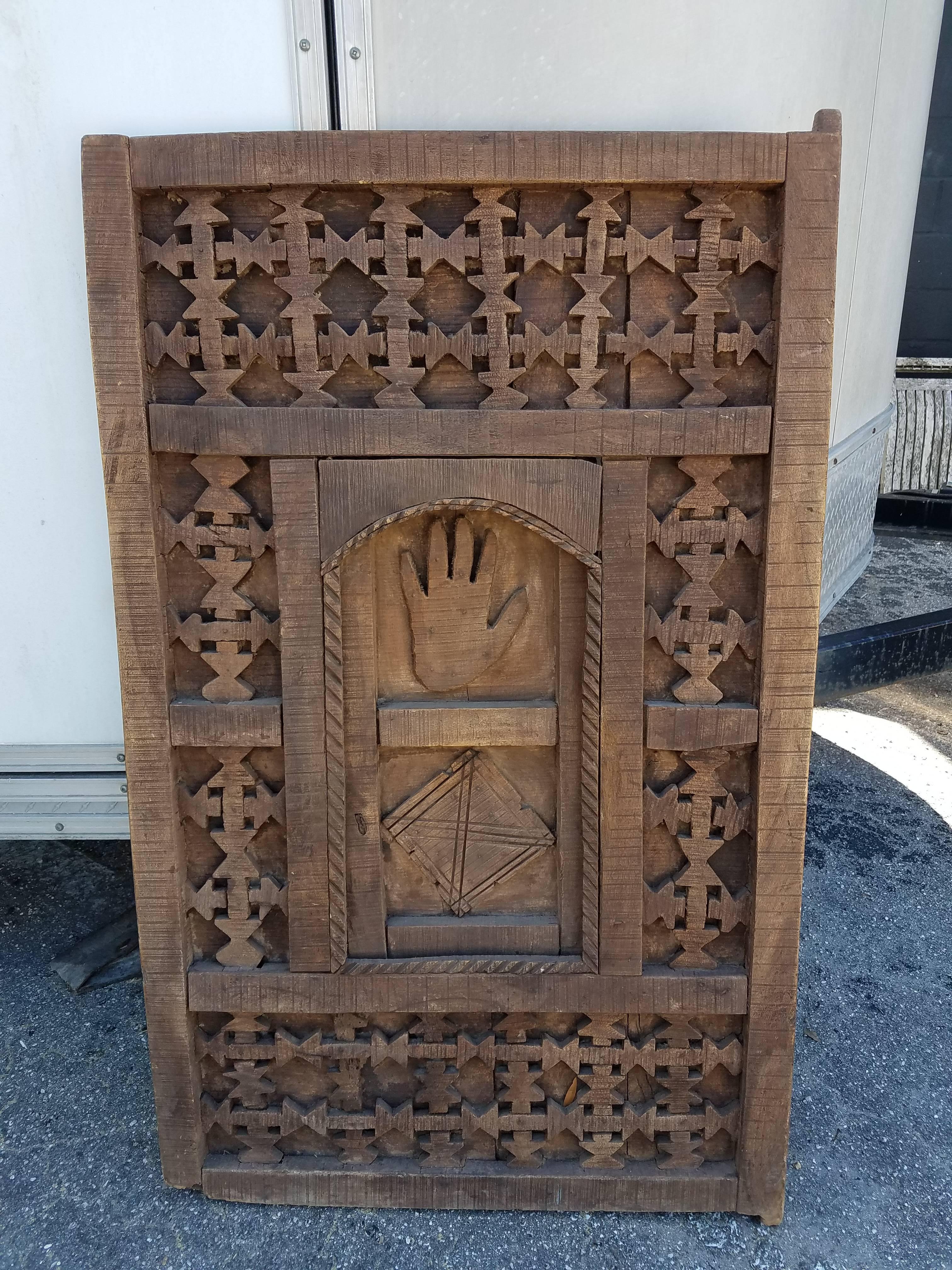 Very old and traditional Moroccan door/shutter. This door was taken from an old home in the Marrakech Medina when the house was being destroyed. Great as a decorative door laying or hanging on a wall and very easy to install if used as a functional