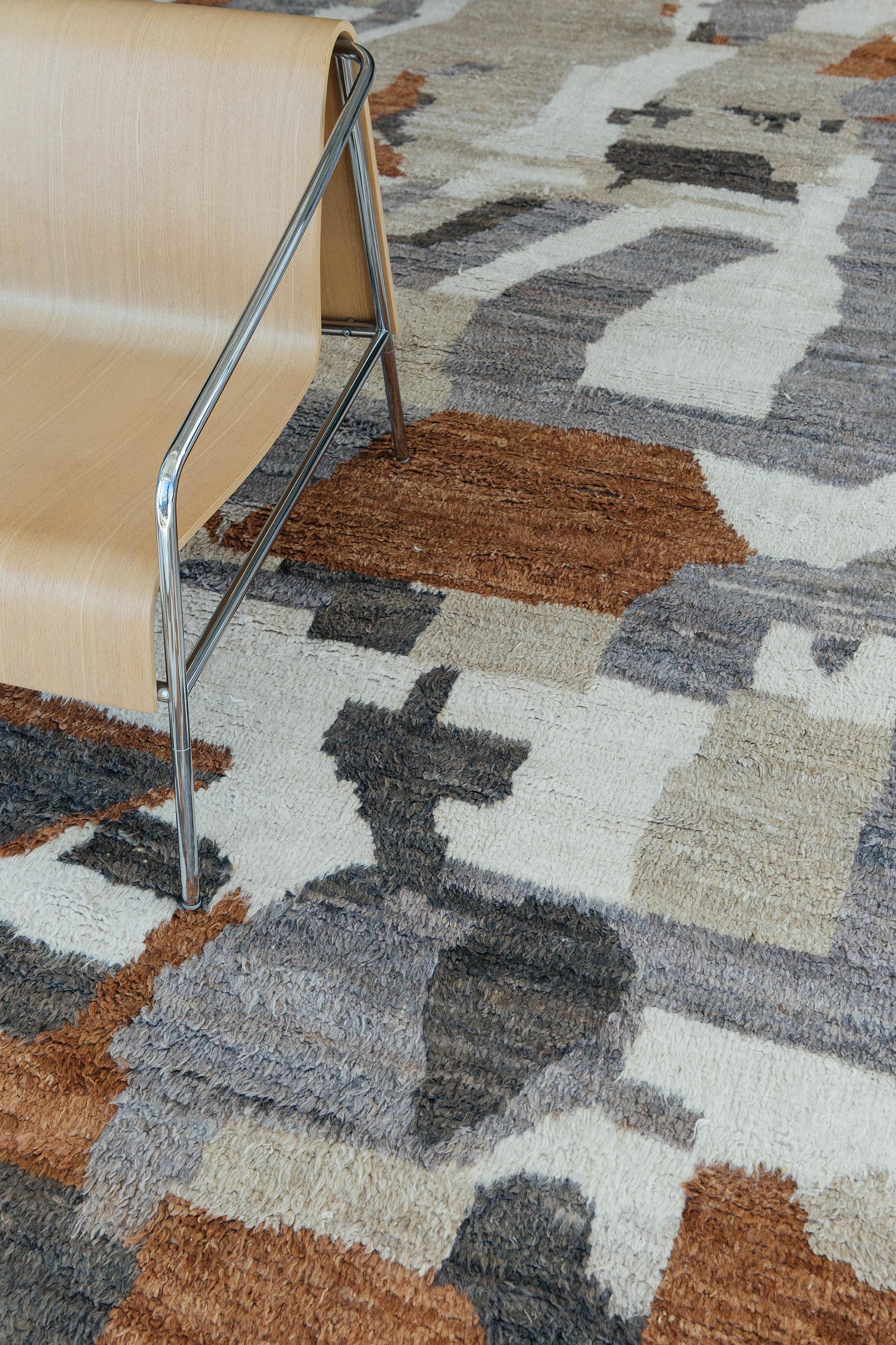 A beautiful shag pile weave and modern-day interpretation of the Moroccan world. The Infrane rug from Mehraban's Atlas Collection is unique for its irregular shapes knitted together with harmonious colors of tiger orange, beige, off-whites, and