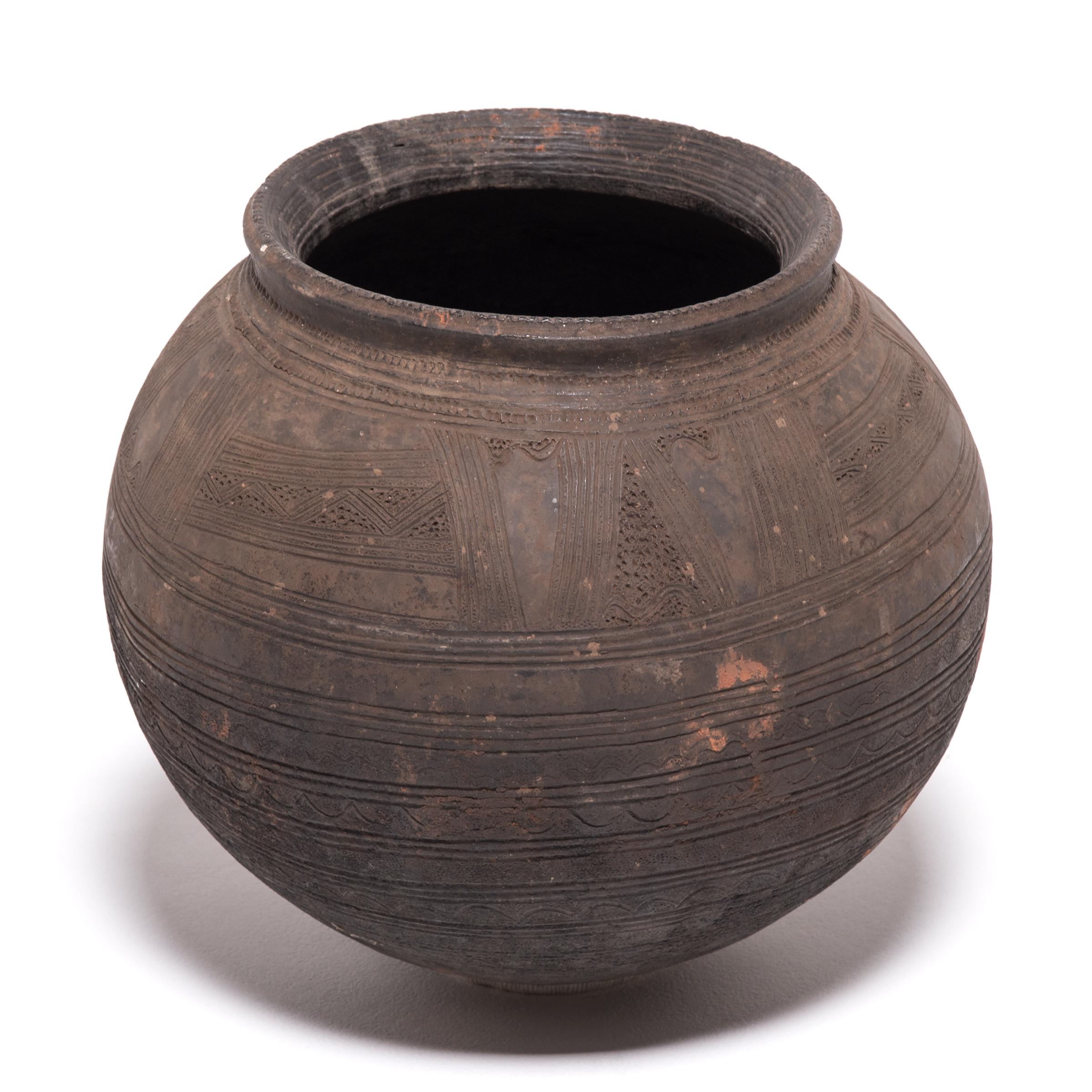 African pottery is revered for combining a simplicity of form with astonishing beauty and sophistication. Even an everyday object, like this water vessel, is richly balanced and deep in character. The vessel's varied textures come from its