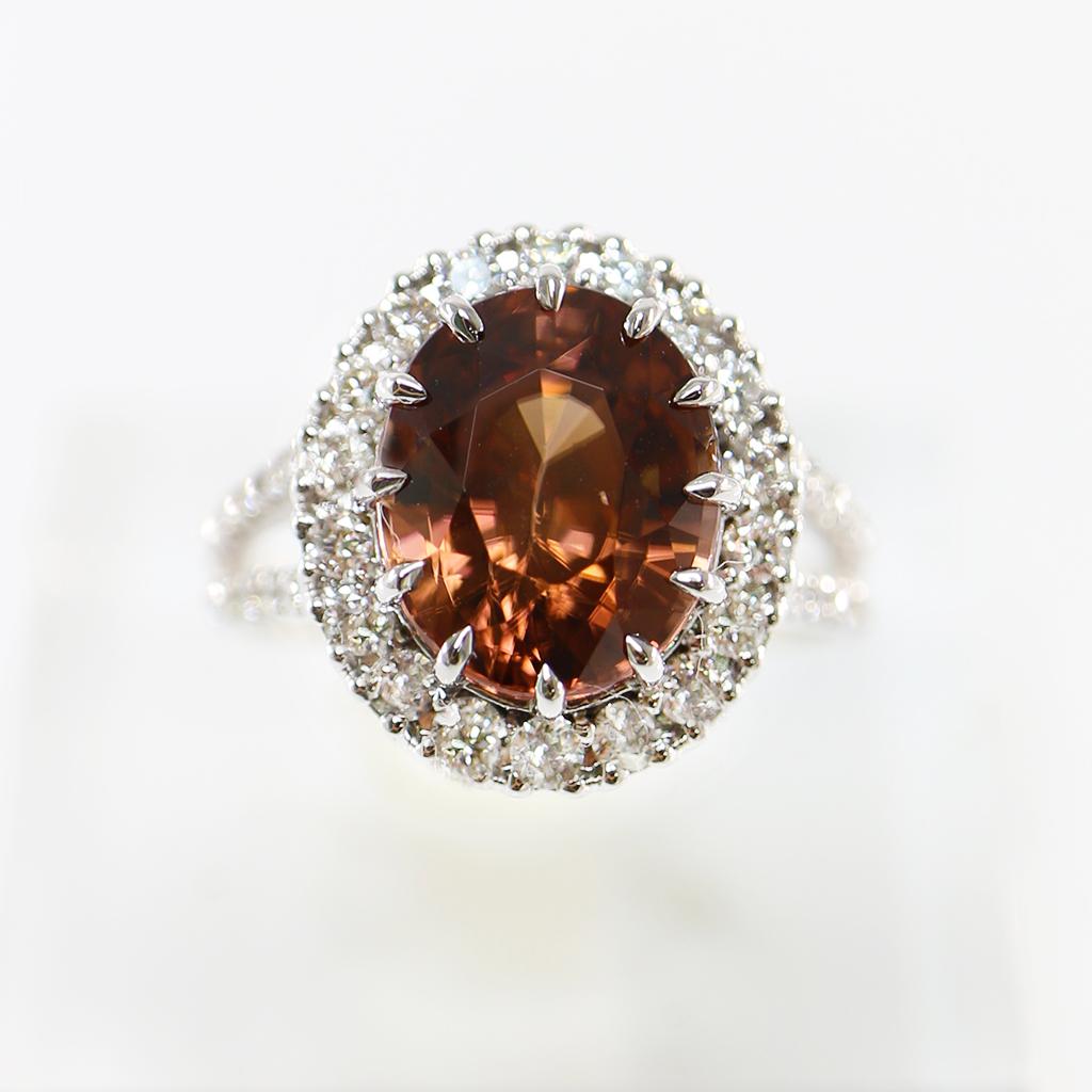 ** One IGI 14K White Gold 5.34 Ct Natural Zircon Diamonds Engagement Ring **

A very rare natural IGI-certified intense orange color Zircon with fire luster weighing 5.34 ct set on the 14K white gold split pave' band used FG VS natural round
