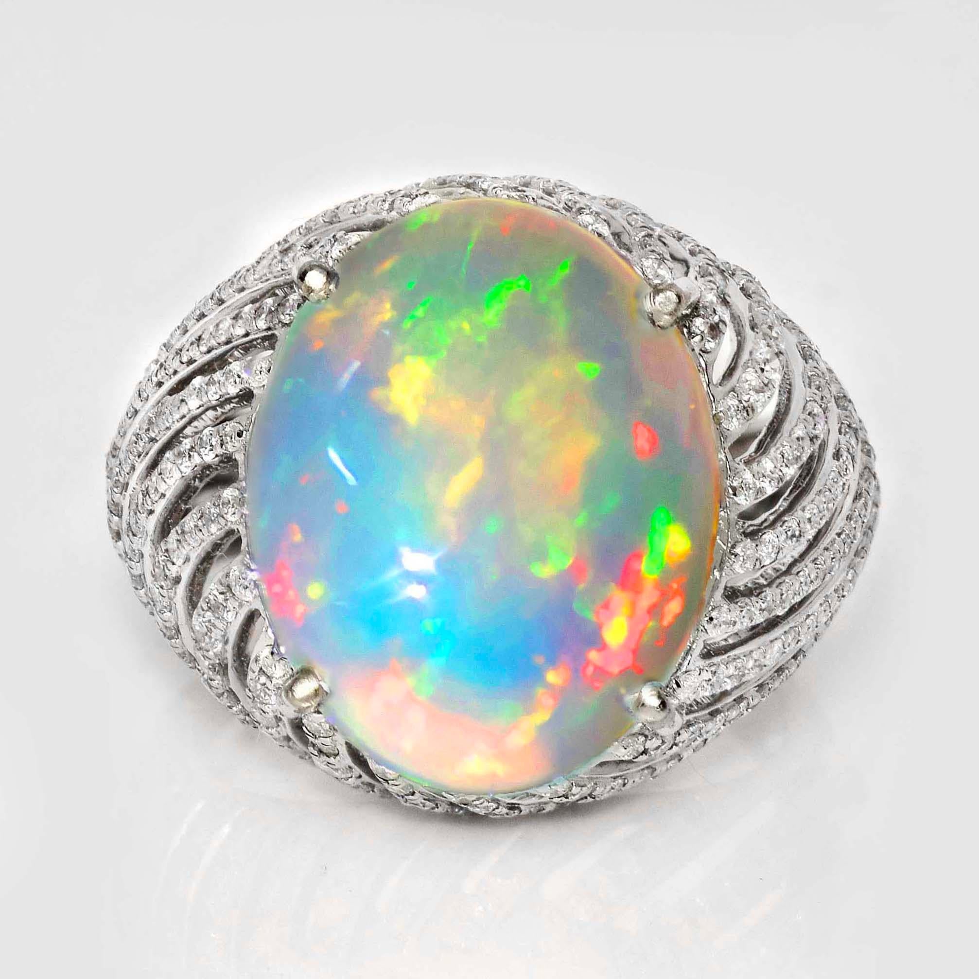 *IGI 14K 8.24 ct  Natural Color Play Opal Diamonds Antique Engagement Ring*
This ring features a 8.24-carat natural white Opal with a color-play effect. It is set on a 14K white gold band and accented with natural F-G, VS diamonds weighing 1.27