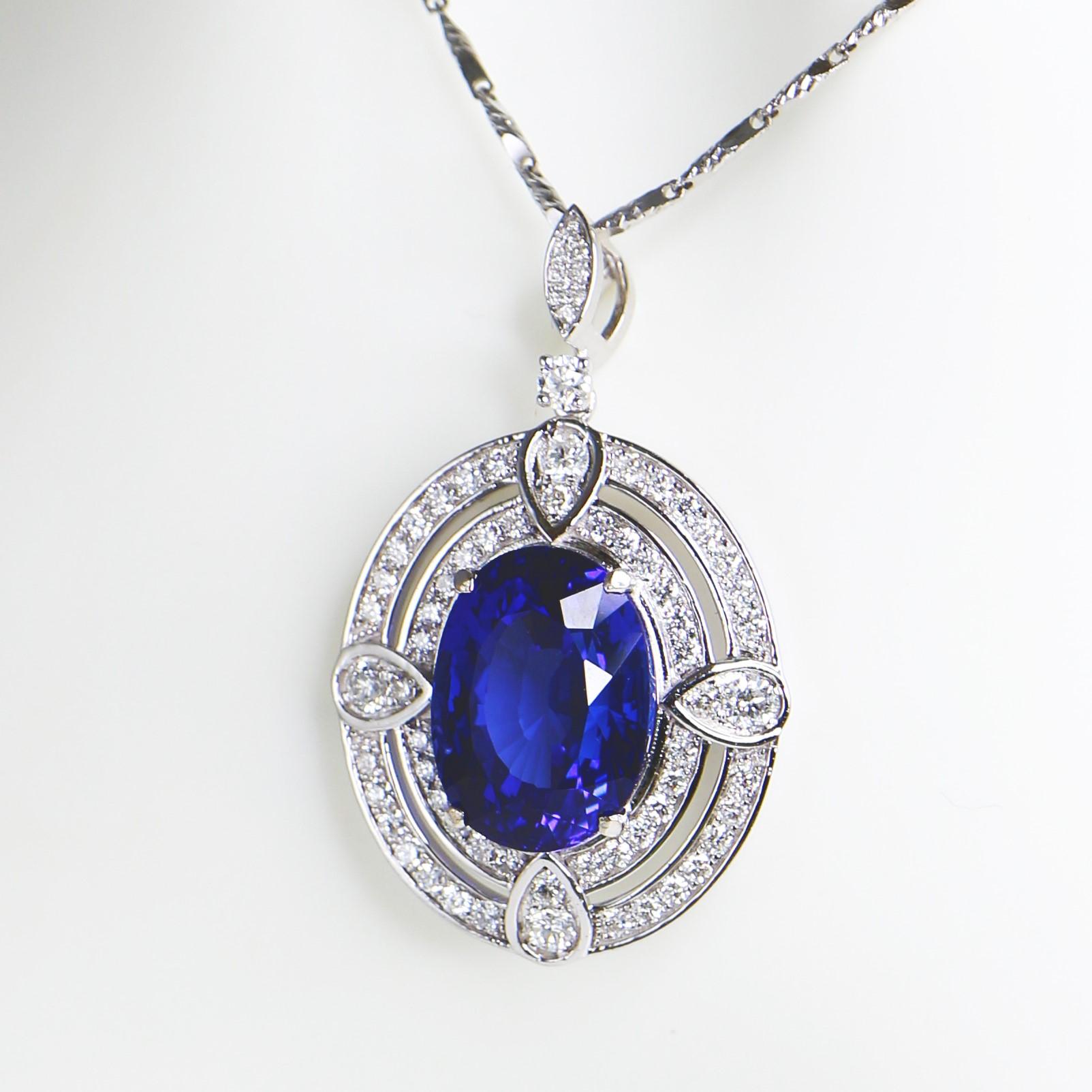 **One IGI 18K White Gold 10.19 Ct Tanzanite&Diamonds Pendant Necklace**

One IGI-Certified natural top-quality vivid blue Tanzanite as the center stone weighing 10.19 ct
surrounding by the FG VS accent diamonds weighing 1.07 ct not only to make the