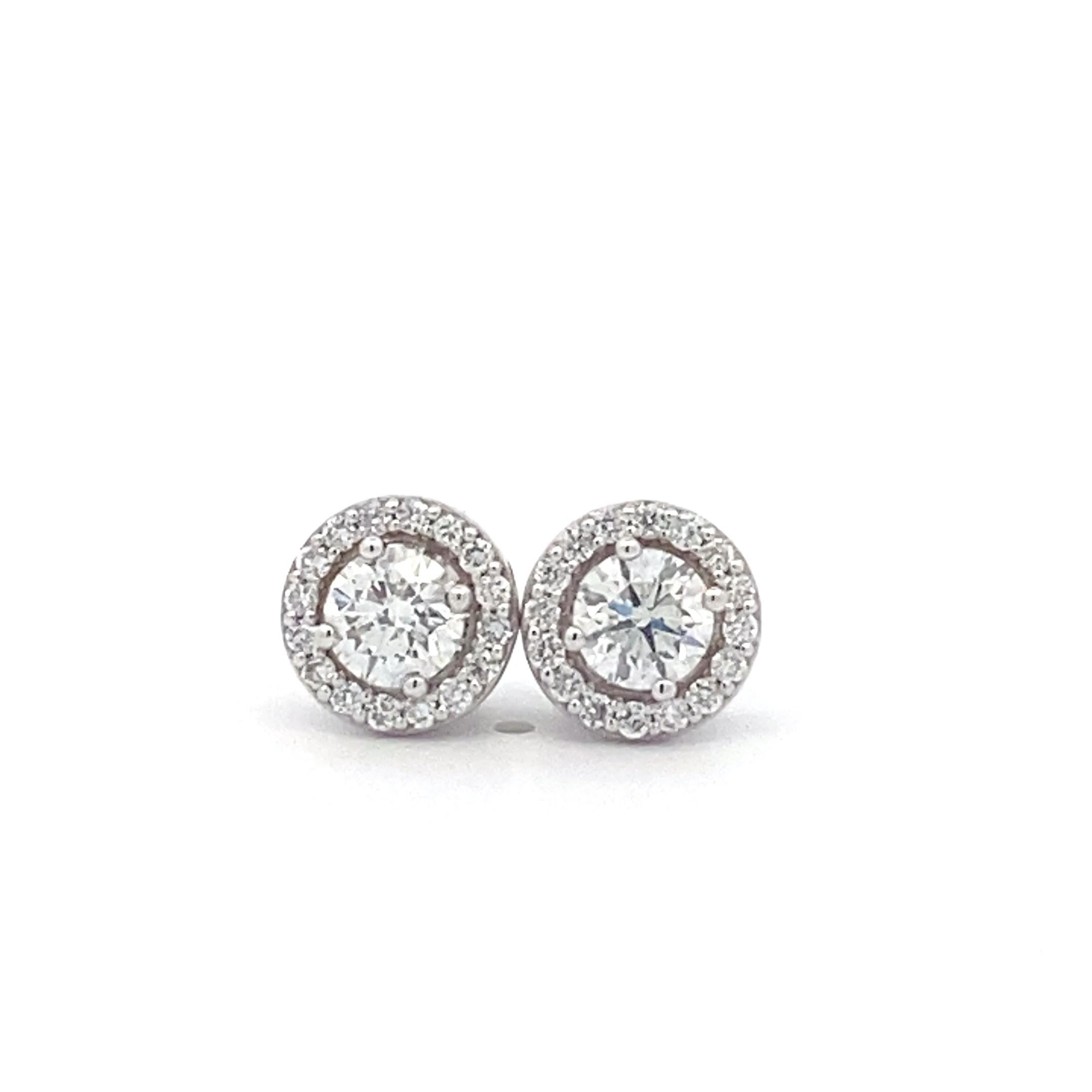 Introducing the stunning IGI 18k White Gold Interchangeable Hoop Earrings, a luxurious and versatile accessory that embodies elegance and glamour. Each earring showcases a dazzling 1-carat center round diamond, radiating brilliance and