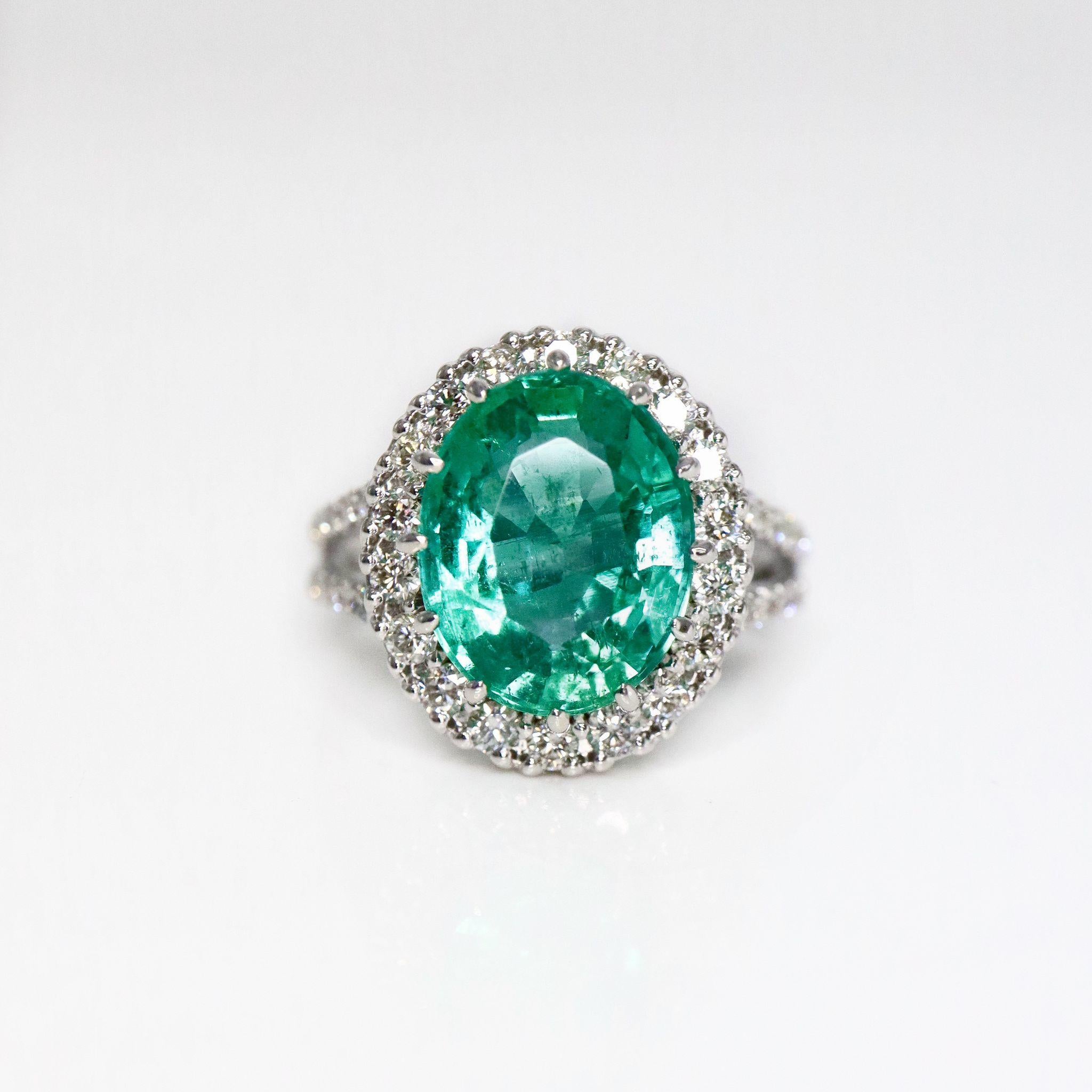 *IGI 3.86 Ct 14K White Gold Emerald Engagement Ring* 

This stunning ring features a 3.86 ct natural Emerald as the centerpiece, certified by IGI. It is set on a 14K white gold band with a halo design, adorned with F-G VS diamonds weighing 0.62 ct.