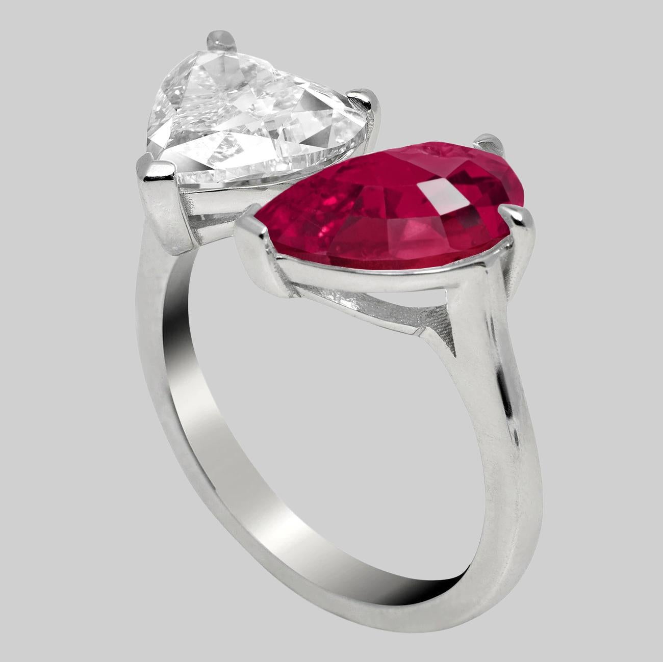 An amazing bypass moi & toi platinum ring set with a 2 carat flawless heart shape diamond certified by GIA and a 3 carat IGI Antwerp pear cut ruby platinum ring.