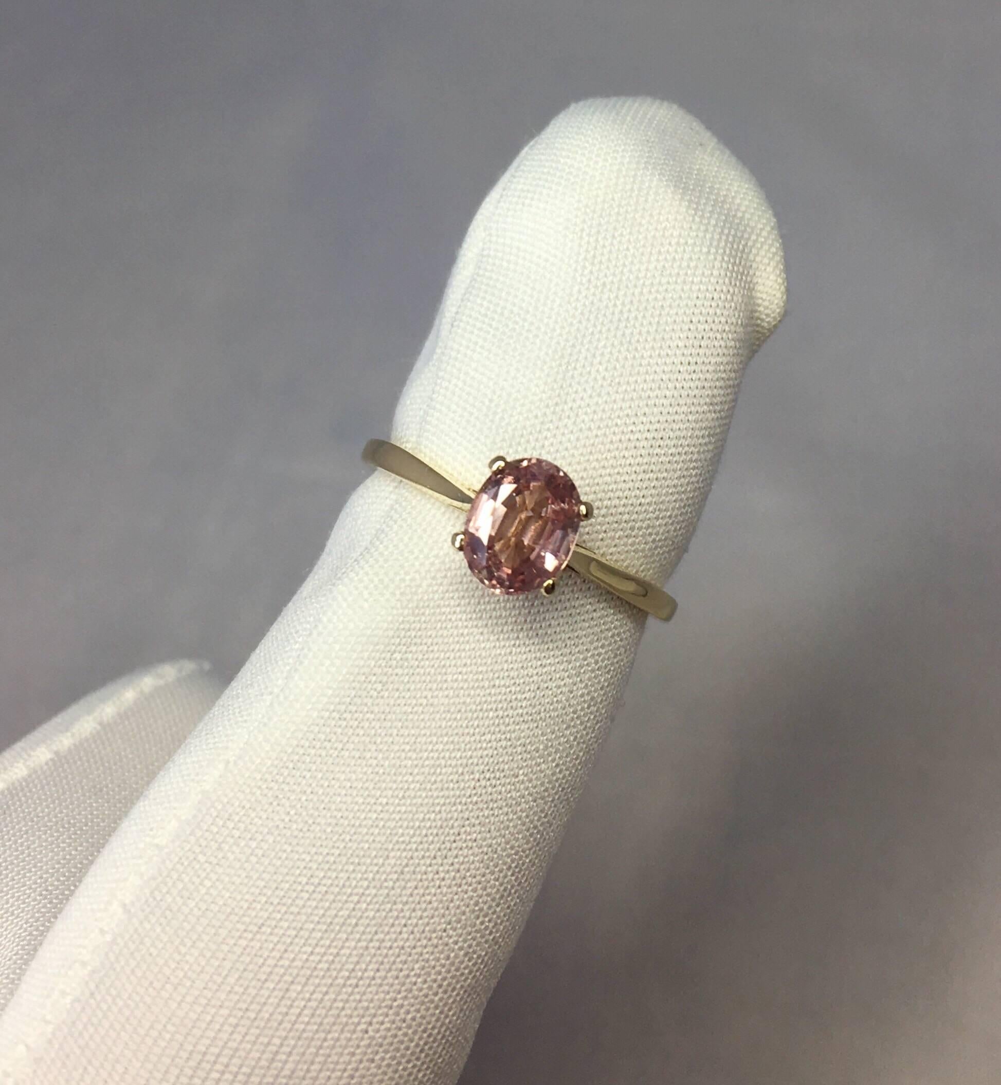 Stunning Ceylon pink orange sapphire set in a fine 14k yellow gold solitaire ring.

Totally untreated and unheated, comes with full IGI report to confirm stone is untreated and Ceylon in origin.

1.10 carat sapphire with stunning colour, described