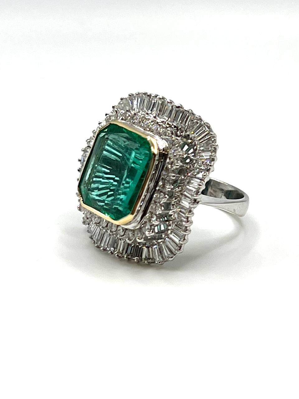 an elegant emerald and diamond ring , set at the center with 8.00 carats Colombian emerald in a surround of round brilliant-cut diamonds and baguette-cut diamonds ( circa 4 carats )
mounted in 18k gold , circa 1950s.
this piece is accompanied by a