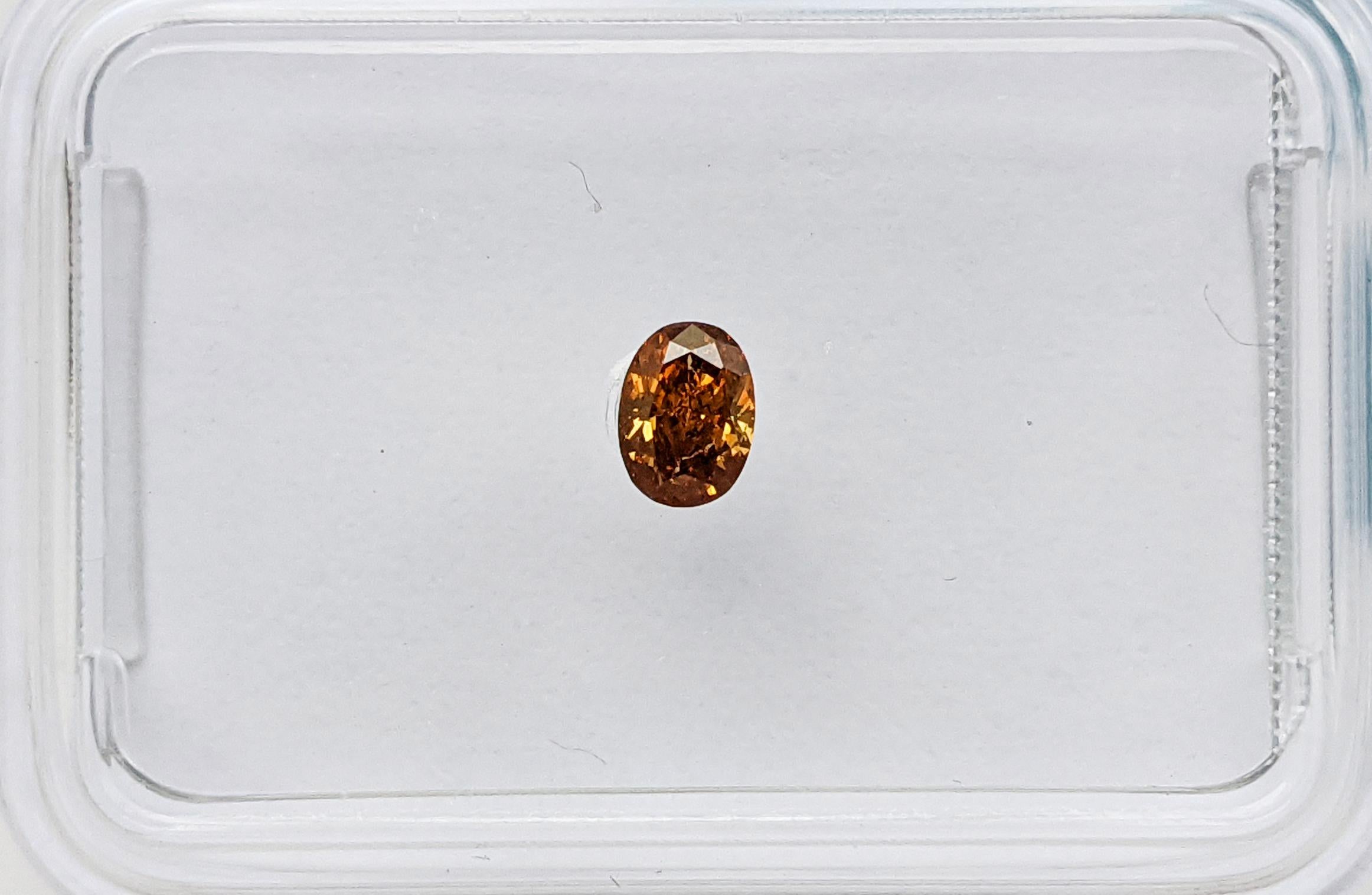 Here's a captivating 0.14ct Oval diamond, certified by IGI. Its striking Fancy Vivid Yellowish Orange hue brings warmth and vibrancy to life. With an SI1 clarity, this diamond offers both beauty and assurance, making it a standout choice for any