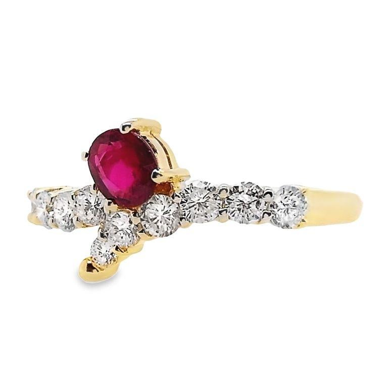 Captivating 18K yellow gold ring featuring an exquisite oval-cut ruby, accented with natural round brilliant diamonds. This ring is a symbol of timeless beauty and sophistication, perfect for those who appreciate the finer things in life.

This ring