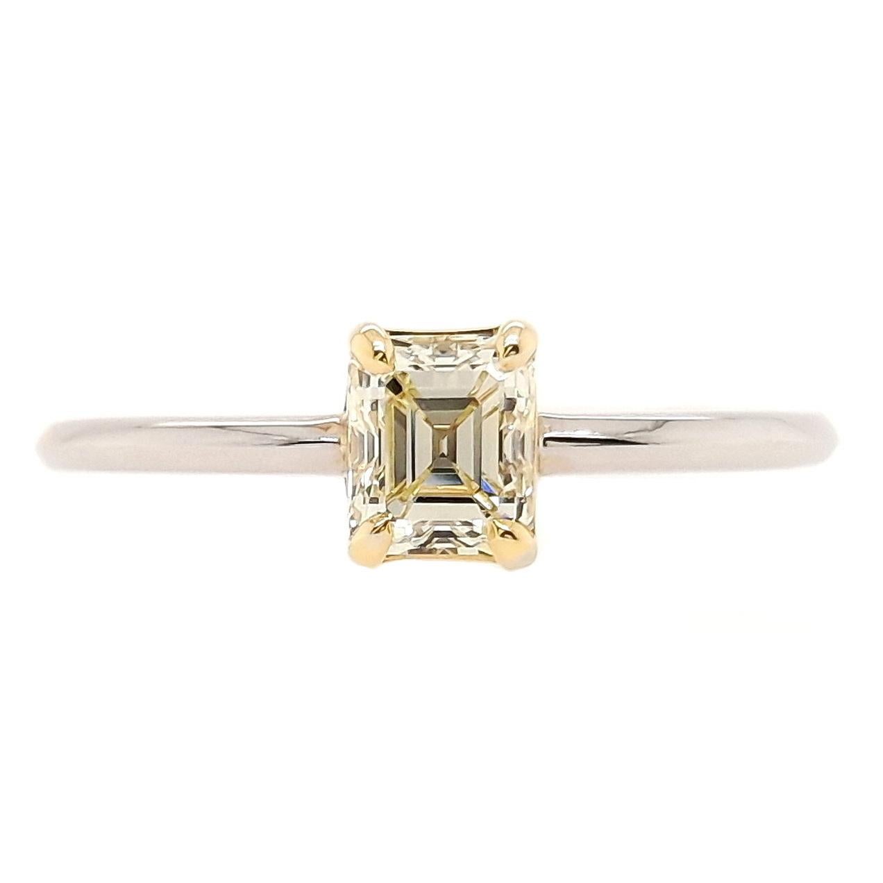 Elegant 14K yellow and white gold ring featuring a 0.61-carat natural fancy yellow VS diamond in an emerald cut. The diamond’s very light yellow colour, coupled with VS clarity, creates a brilliant and sophisticated design. Weighing 1.83 grams, this