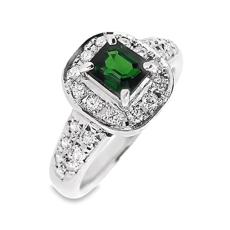 Unveil opulence with our Top Crown Jewelry House collection platinum ring—showcasing a regal emerald-cut tsavorite embraced by a shimmering array of natural round brilliant diamonds. Make a statement of timeless glamour and allure.

This ring is