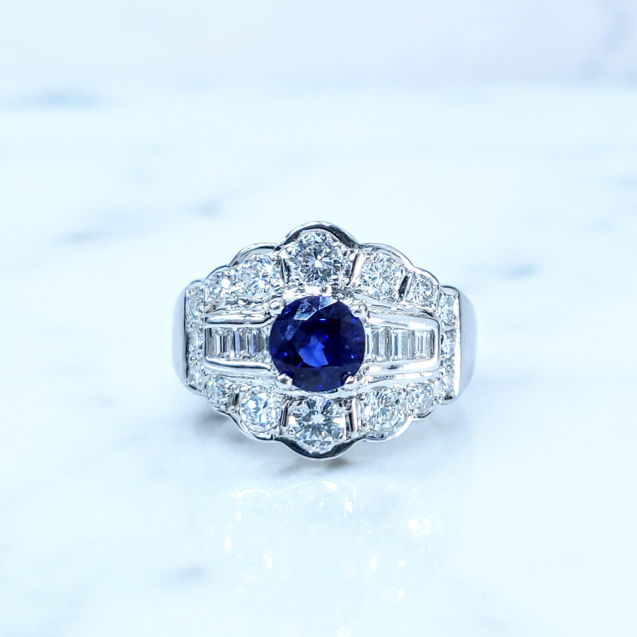 This striking ring showcases a captivating 0.73-carat round mixed cut sapphire, a gem that exudes both classic elegance and a truly royal blue hue. This mesmerizing color, reminiscent of the finest sapphires sought after throughout history, is rich,