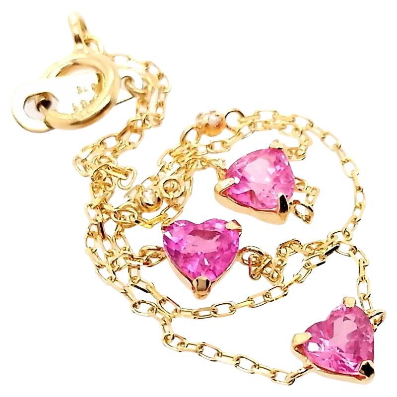 This elegant 18K Yellow Gold Bracelet is set with 0.86ct Natural Pink Sapphires and 0.02ct Natural Diamonds. The bracelet features 3 heart-shaped mixed-cut pink sapphires with an intense purplish-pink hue, transparent clarity, and natural