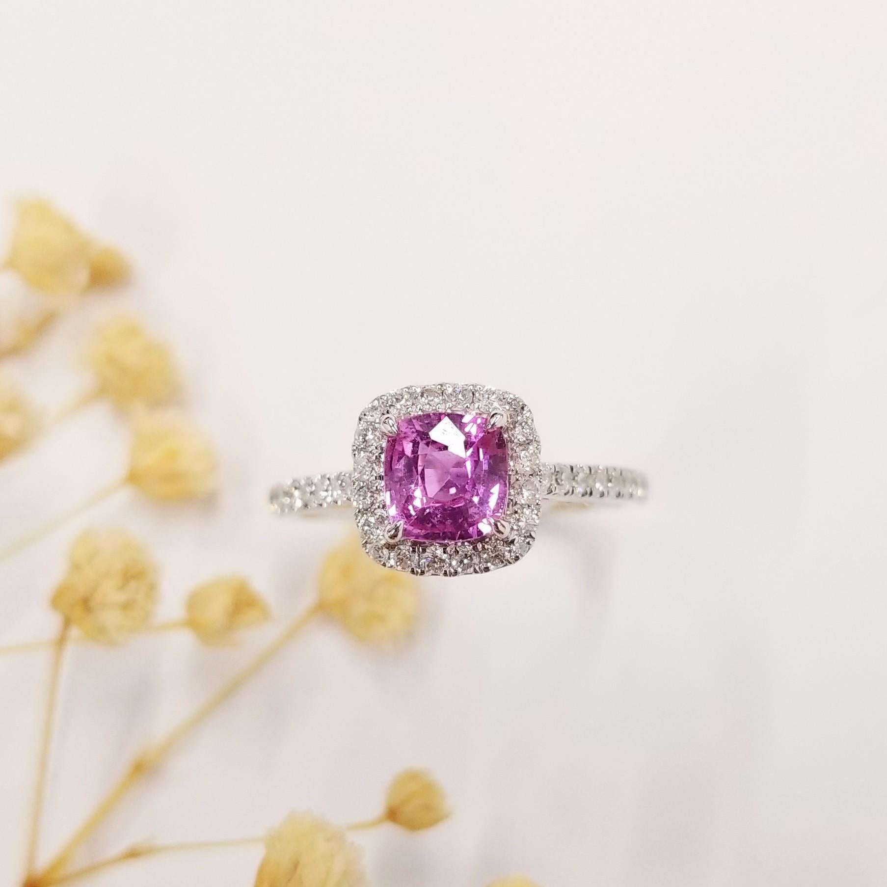 Crafted meticulously in 18K white gold, this exquisite ring exudes elegance and sophistication, making it a perfect addition to any jewelry collection.

Central to this captivating ring is a mesmerizing 0.90 Carat intense purplish pink natural