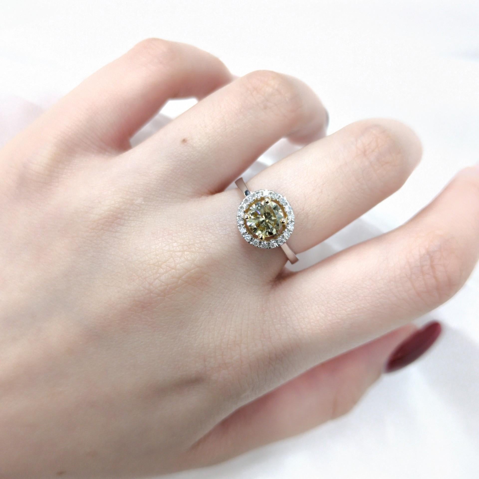 This exquisite ring features a captivating 1-carat round brilliant-cut Fancy Brownish Yellow diamond as its centerpiece. The diamond, with its warm, unique color, is set in a classic four-prong setting, allowing its brilliance and character to