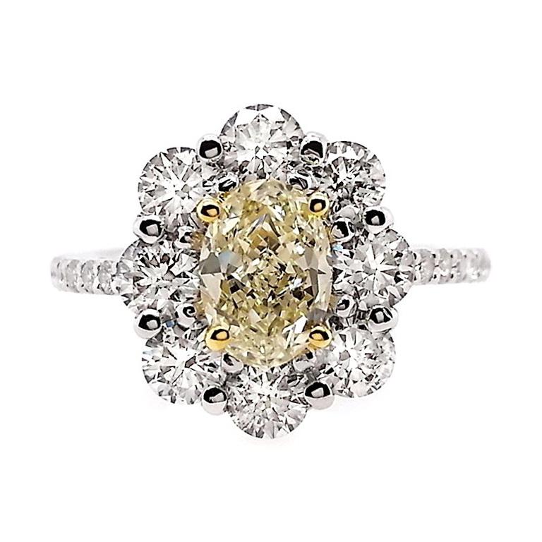 Bask in the radiance of a light-yellow 1-carat oval diamond surrounded by 1.38-carats of dazzling natural diamonds. This elegant arrangement captures the essence of timeless beauty, creating a piece that exudes sophistication and brilliance.

This