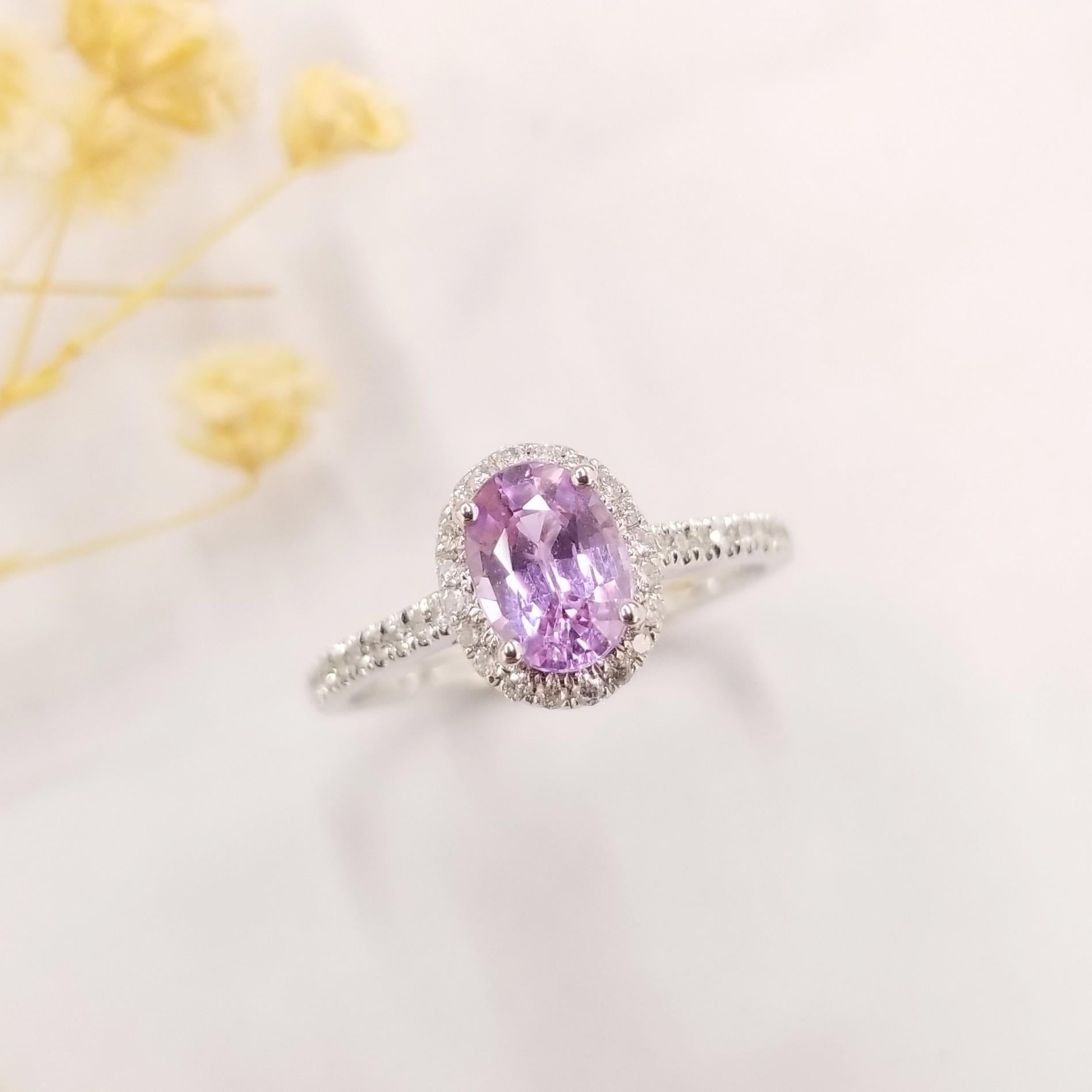 A beautiful cushion cut 1.04 carat Purple sapphire, set with a halo of diamonds. Handmade in 18K white gold with a total diamond weight of 0.21carats

