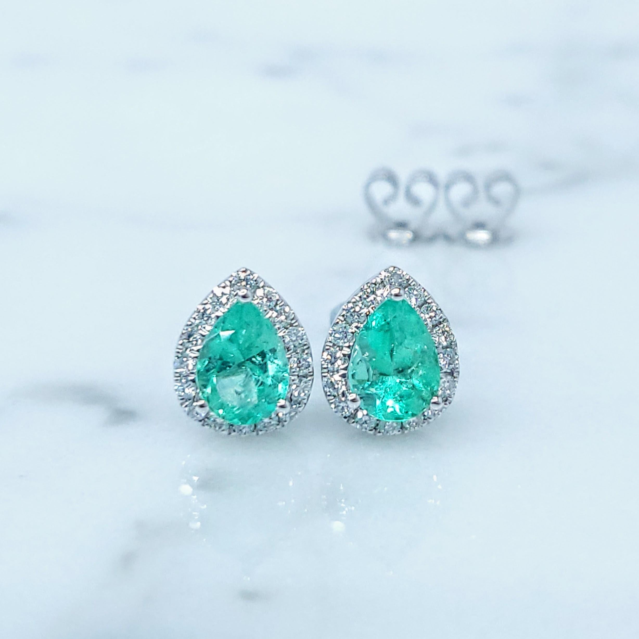 These exquisite 18k white gold earrings whisper tales of ancient Colombian mines and the timeless allure of emeralds. Two pear modified brilliant-cut emeralds, totaling 1.08 carats, are the stars of this elegant pair. Each emerald, measuring 6.70 x