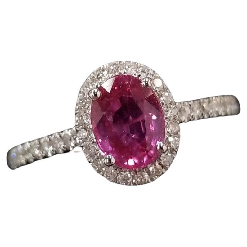 Behold the captivating beauty of this IGI Certified 1.08 Carat Pink Sapphire Ring. This exquisite piece features a lustrous oval-shaped pink sapphire, certified by IGI, showcasing an intense pink color that is both rare and mesmerizing. Set in an