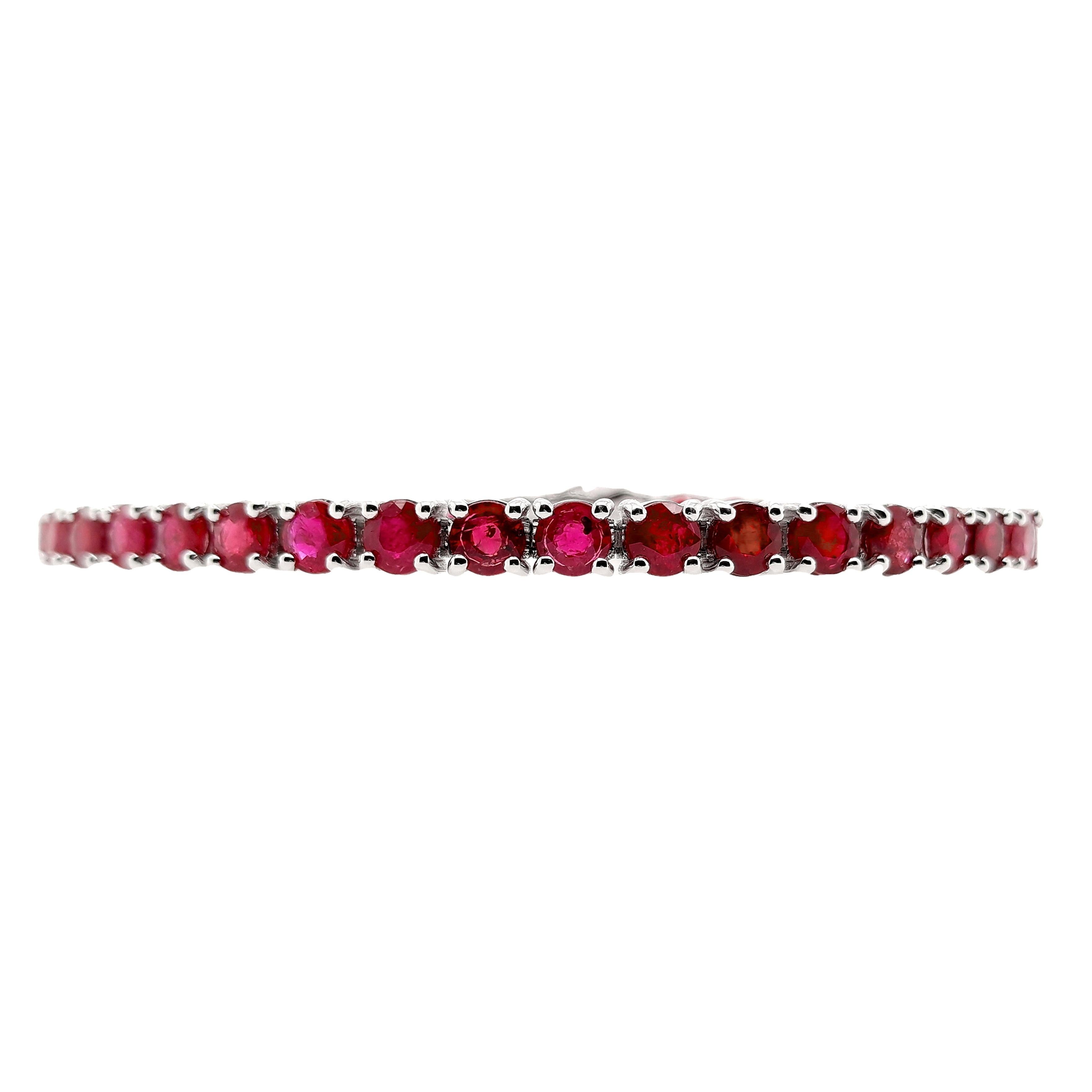 Exquisite 14Kt White Gold Bracelet adorned with 10.93ct of Natural Rubies, certified by IGI. This luxurious piece features 40 round mixed-cut rubies, each showcasing a captivating intense purplish-red to deep red hue, enhanced by expert heating