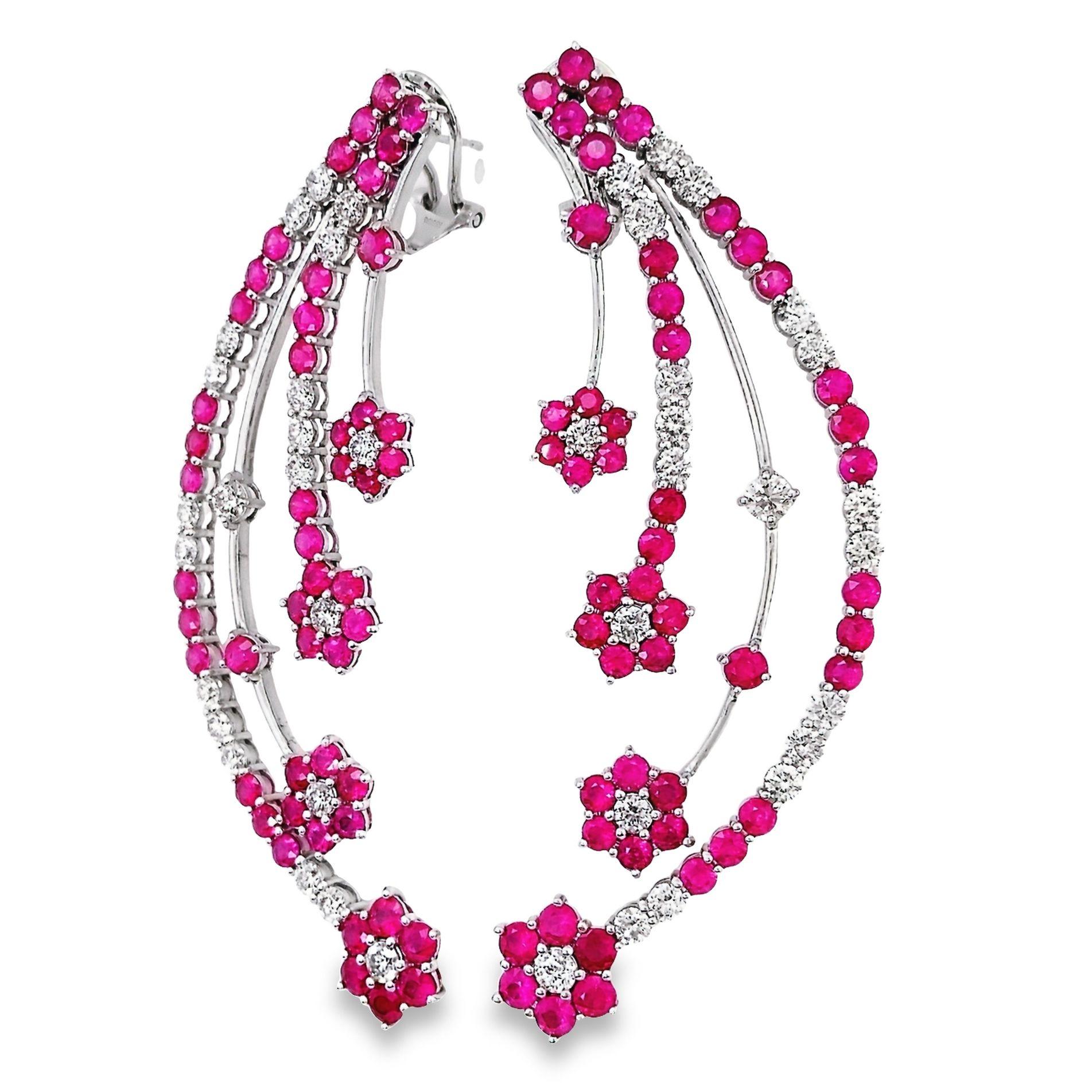 Immerse yourself in the enchanting allure of these rare earrings by Top Crown Jewelry, where pure luxury takes centre stage. A mesmerizing 10 carats of round-cut Burma rubies, displaying intense to vivid pink hues, captivate the beholder. Enhanced
