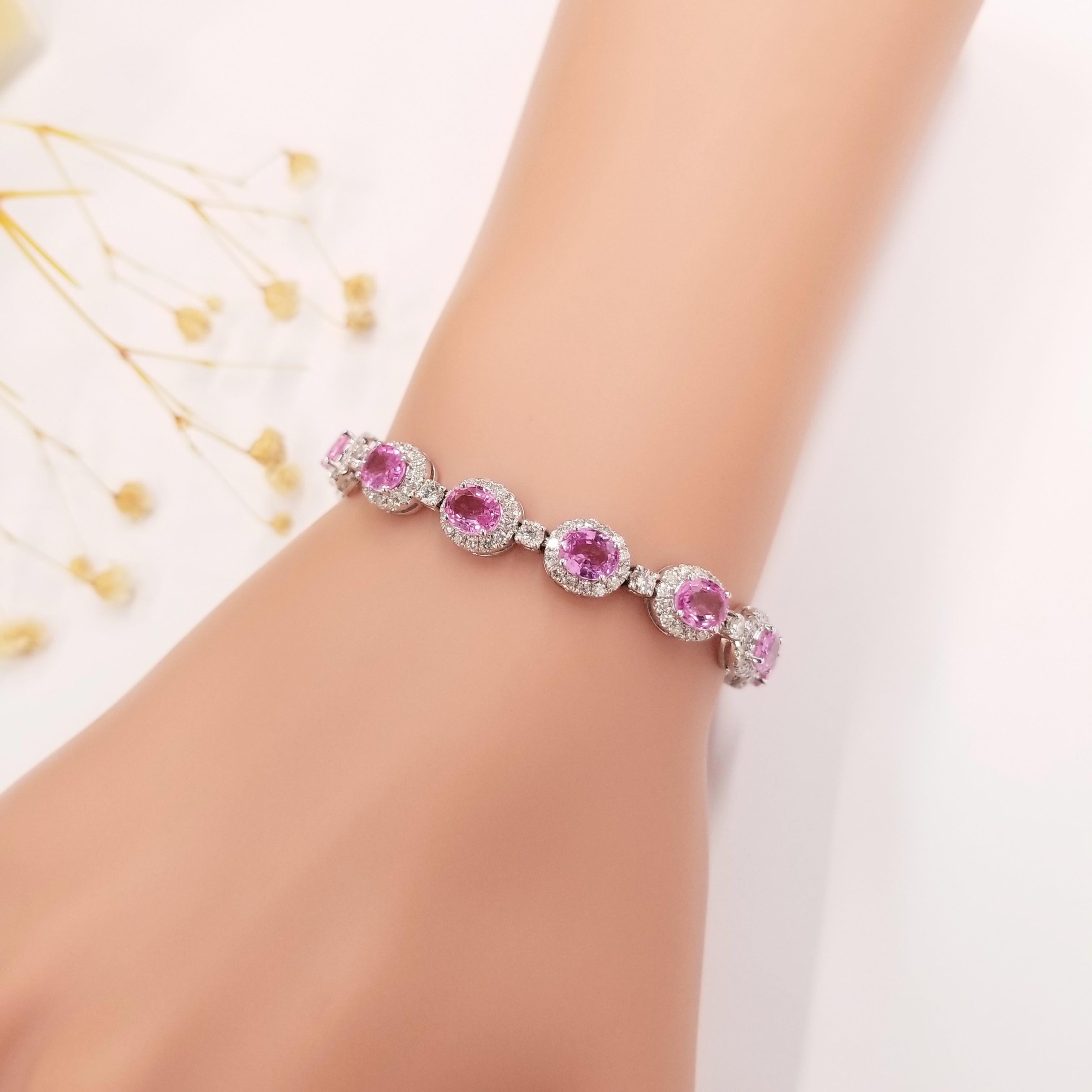 Introducing the breathtaking IGI Certified 11.08Ct Pink Sapphire & Diamond Bracelet in 18K Gold. This exceptional bracelet showcases a collection of oval-shaped pink sapphires, each exuding an intense purplish pink color. With a weight of