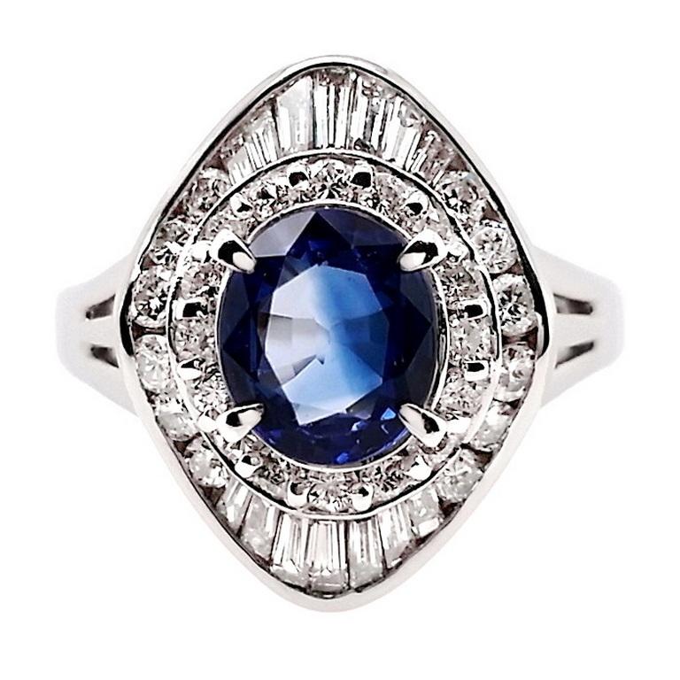 This vibrant ring from Top Crown Jewelry collection, distinctive through its display of the sapphire gem the color of the deepest oceans.
This oval 1.17-carats intense-blue sapphire centre stone is accented by 100% natural glistening mix-shaped