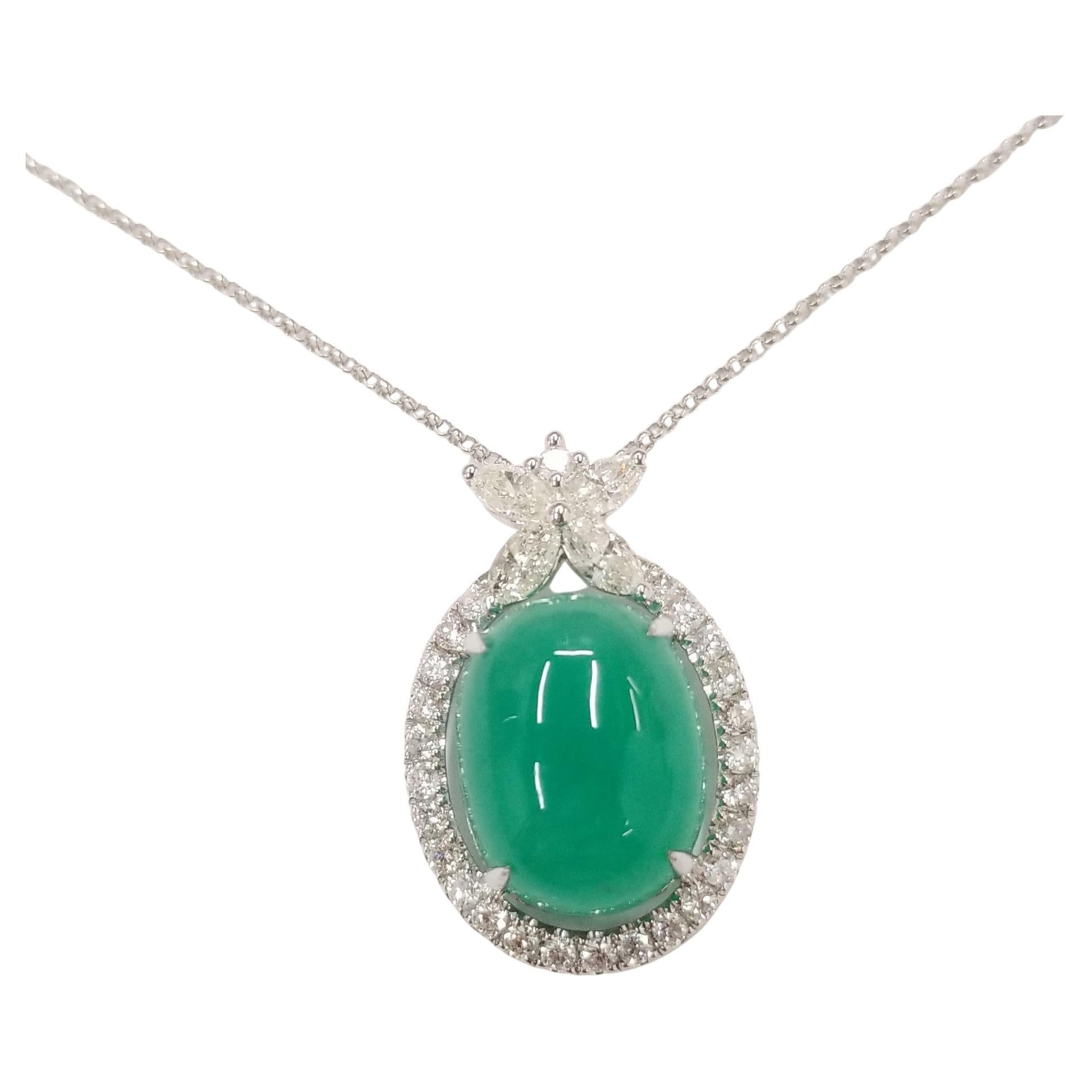 Stunning emerald pendant of superb color, with bezel set diamond halo and decorative marquise diamond holder design. 
A single 12.09 carat oval cabochon emerald, and 1.20 carats of natural diamonds make up to a 13.29 carats total gemstone