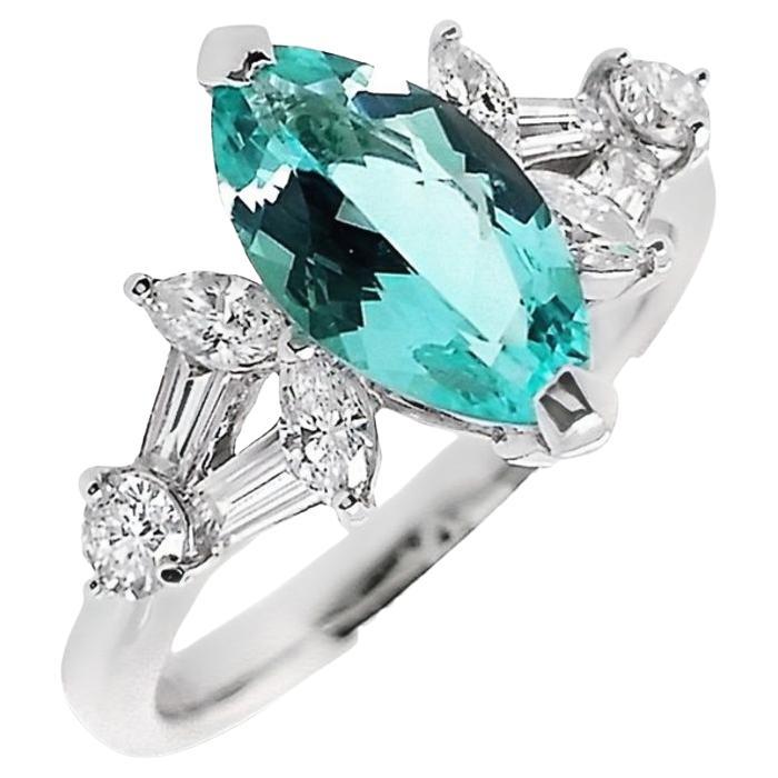 Magnifique bague en platine sertie d'une tourmaline Paraiba Nature de 1,28ct et de diamants naturels de 0,55ct. La pièce maîtresse est une captivante tourmaline Paraiba modifiée en forme de marquise et taillée en brillant, d'une couleur vert bleuté