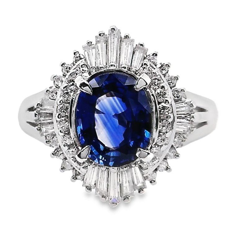 Step into the realm of ultimate luxury with our exclusive offering from the esteemed House of Top Crown Jewelry. Behold a magnificent 1.30-carat vivid blue sapphire, expertly crafted in an oval shape, elegantly set in a platinum ring. This regal
