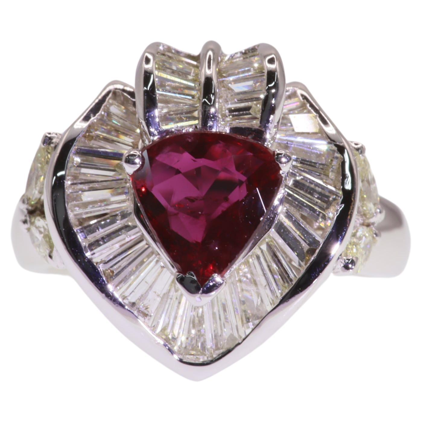 Indulge in the ultimate expression of elegance and luxury with this mesmerizing IGI Certified 1.35 Carat Pear-Shaped Ruby Ring. This captivating piece showcases a vivid purplish red ruby, certified by IGI, in a stunning pear shape that radiates