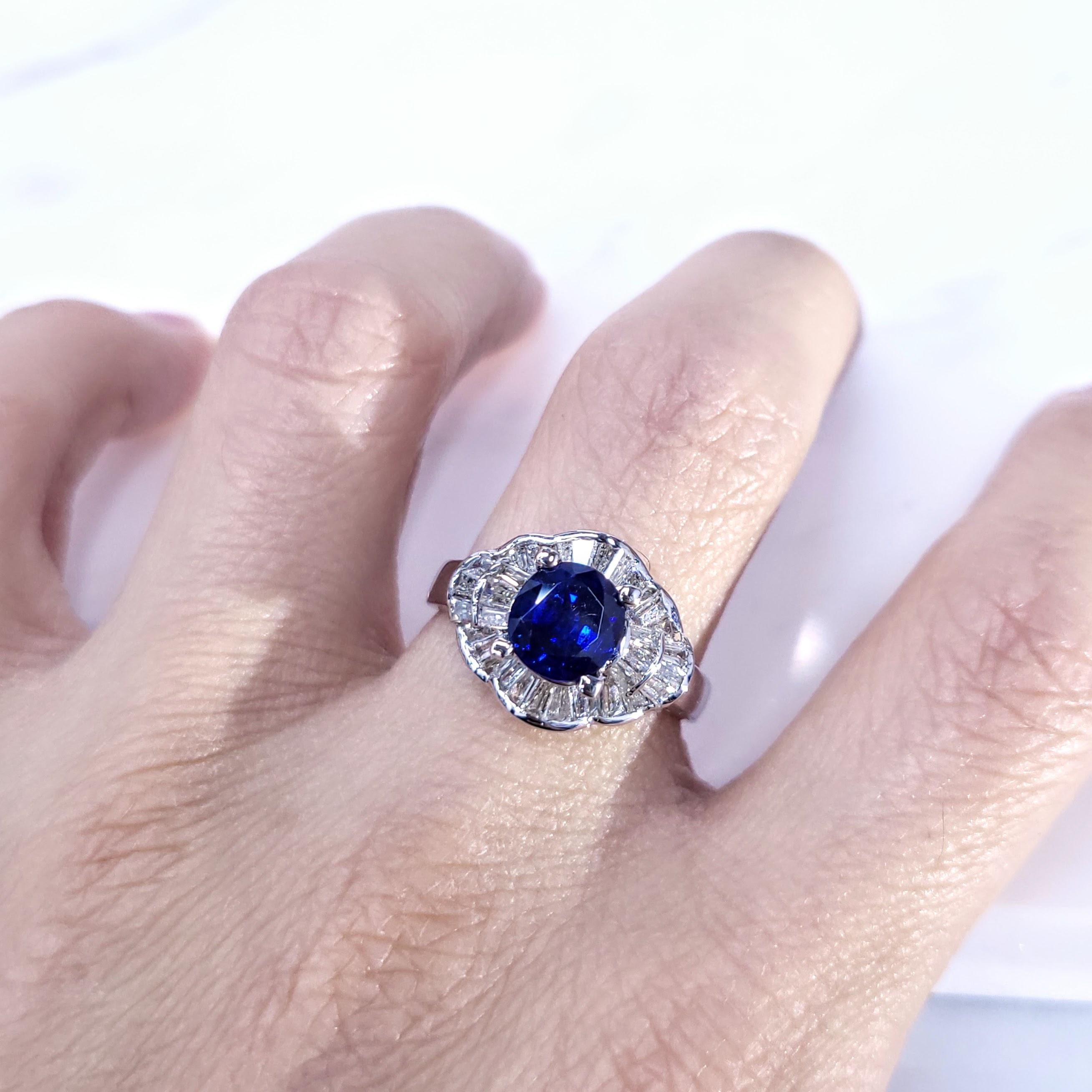 Introducing a truly exceptional piece of jewelry, the IGI certified 18K white gold 1.65ct blue sapphire from Sri Lanka and 0.60ct natural white tapered baguette cut diamond ring. This exquisite ring showcases the rare beauty of blue sapphire, known