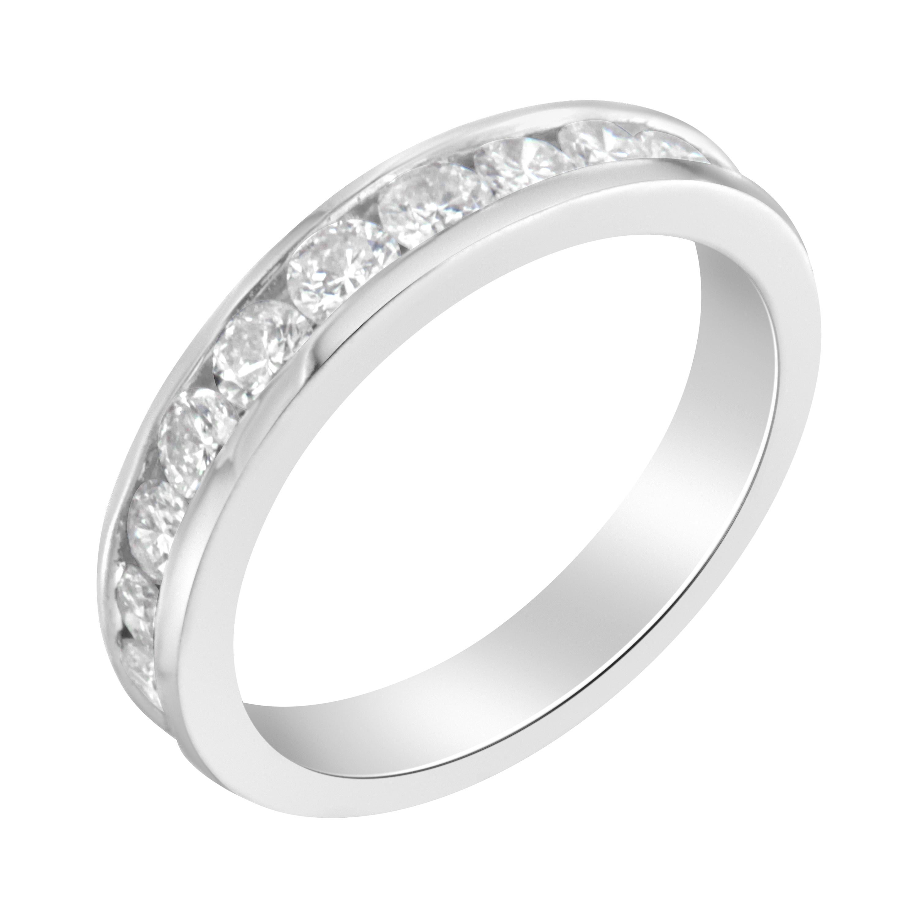 This diamond semi-eternity band features a row of brilliant cut round diamonds channel set in an 18 karat white gold band. There are 11 natural, round-cut diamonds for a total weight of 1 carat. Each band comes with a certificate from IGI for added
