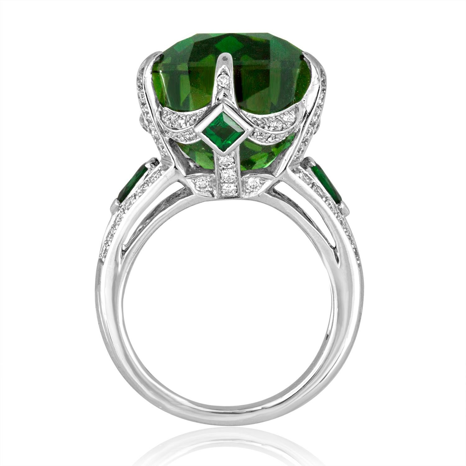 One-Of-A-Kind Ring
The ring is 18K White Gold
The center stone is a 19.00 Carat Tourmaline
Accented by 0.60 Carats of Tsavorite
Surrounded by 0.92 Carats in Diamonds G/H SI.
The ring is a size 6.25, sizable.
The ring weighs 11.3 grams
The ring comes