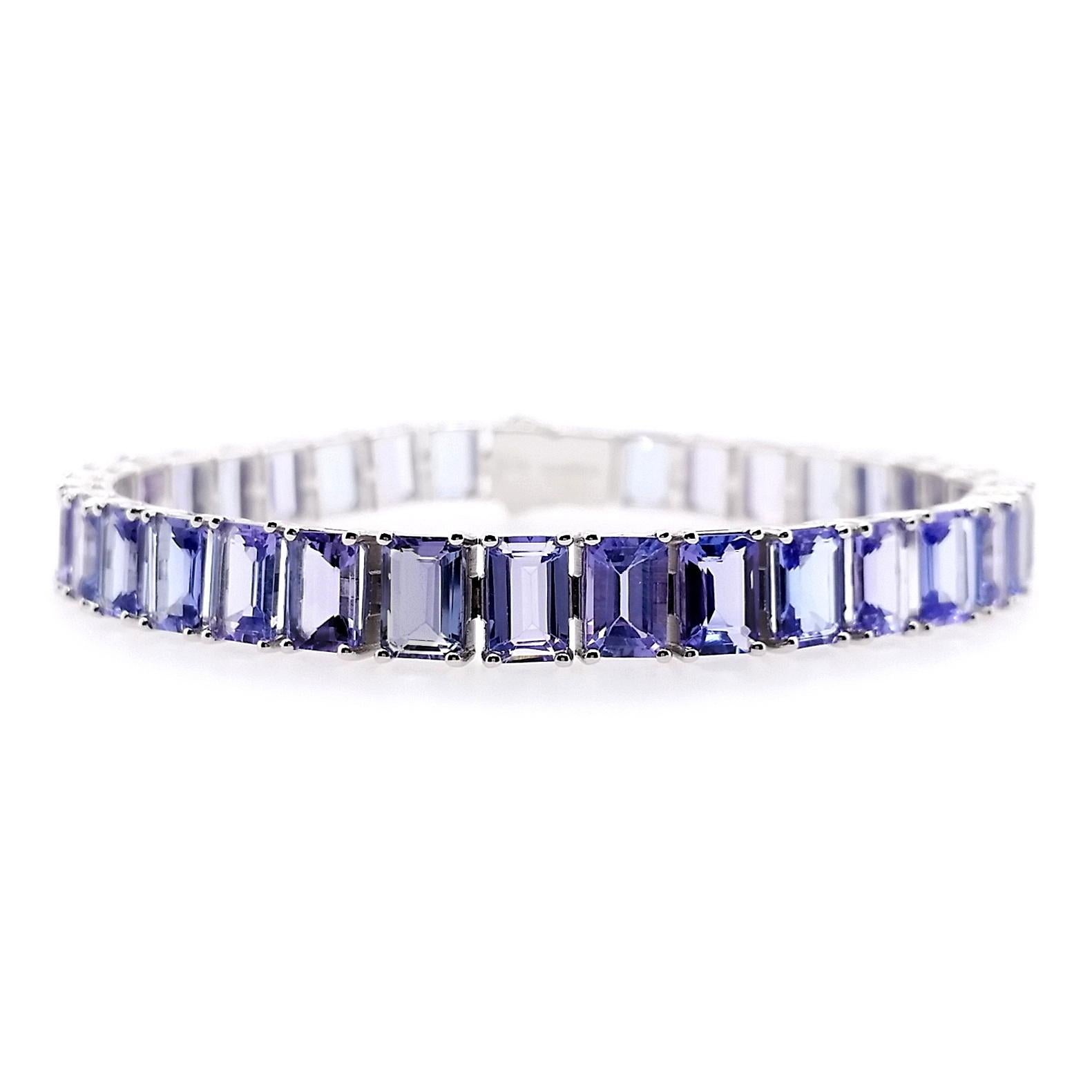 This dazzling 14K White Gold Bracelet from Top Crown Jewelry is a classic, alluring design set with a natural emerald-cut natural Tanzanites, to add the perfect glamour to any look.

This bracelet is certified by IGI laboratory, report number:
