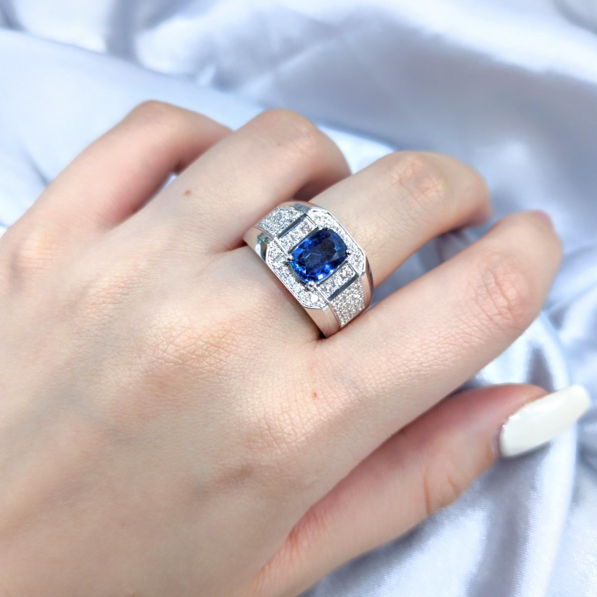 Imagine a ring that commands attention, a statement of refined elegance and timeless style. This is that ring.

Behold the centerpiece: A breathtaking 2.06-carat cushion-cut Sapphire, its intense violetish blue hue, certified by IGI, captures the