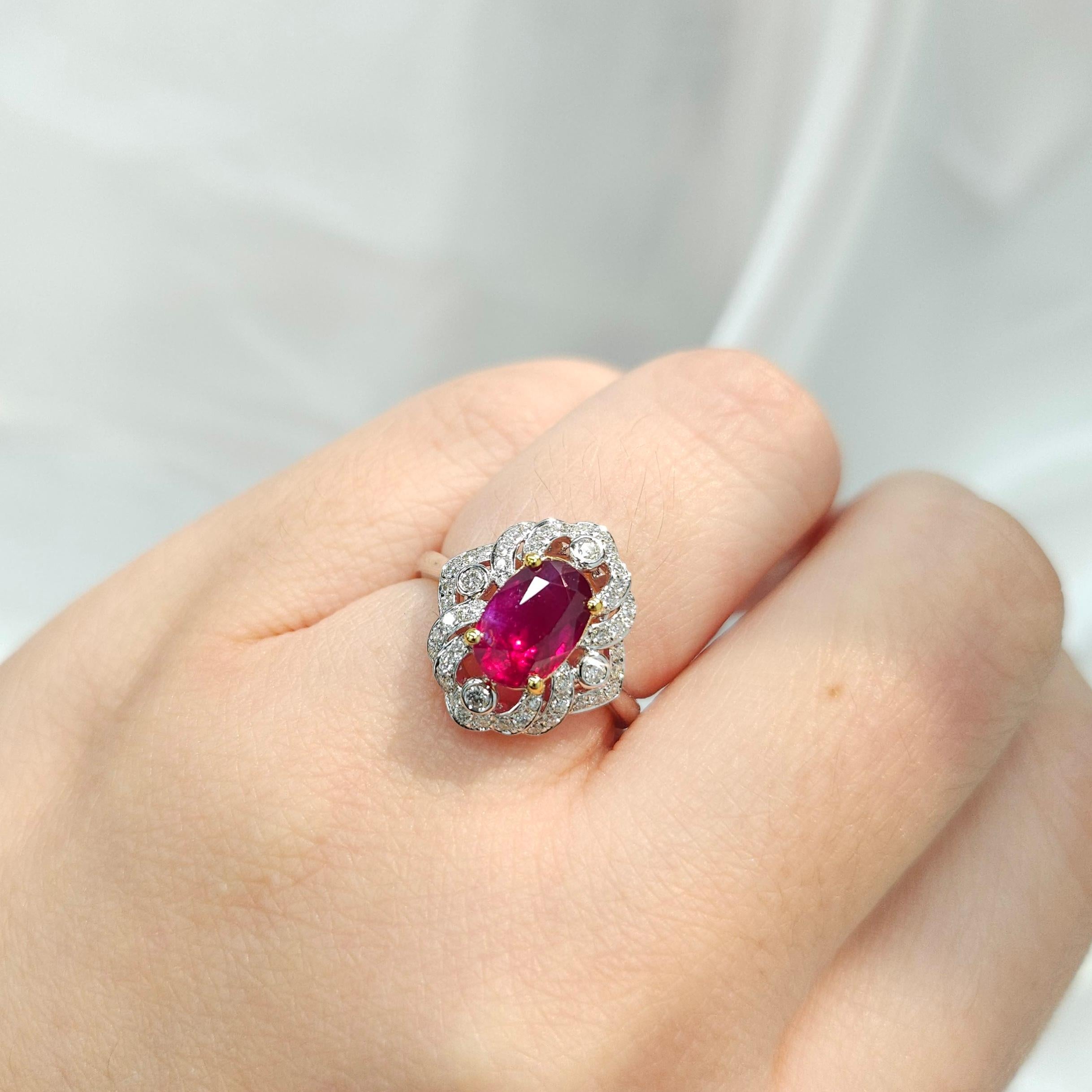 Indulge in the opulent beauty of this exquisite IGI Certified 2.07 Carat Ruby and Diamond Antique Style Ring, a piece that exudes elegance and sophistication in every detail. The centerpiece of this magnificent ring is a rare and alluring 2.07 carat