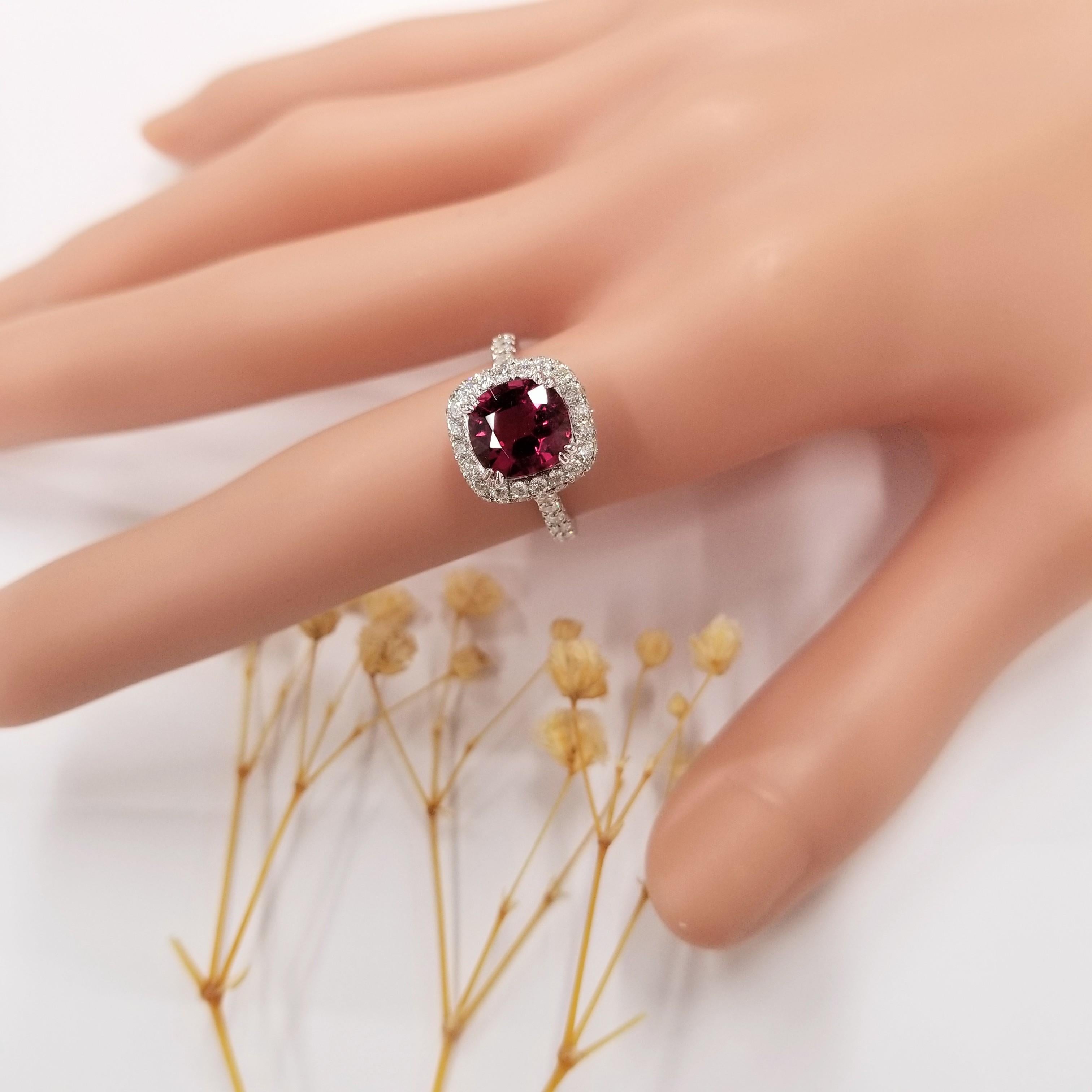 Introducing a show-stopper that will take your breath away, behold the IGI Certified 2.11 Carat Red Tourmaline Ring. This extraordinary piece features a stunning cushion-shaped red tourmaline that has been certified by IGI, showcasing a vivid