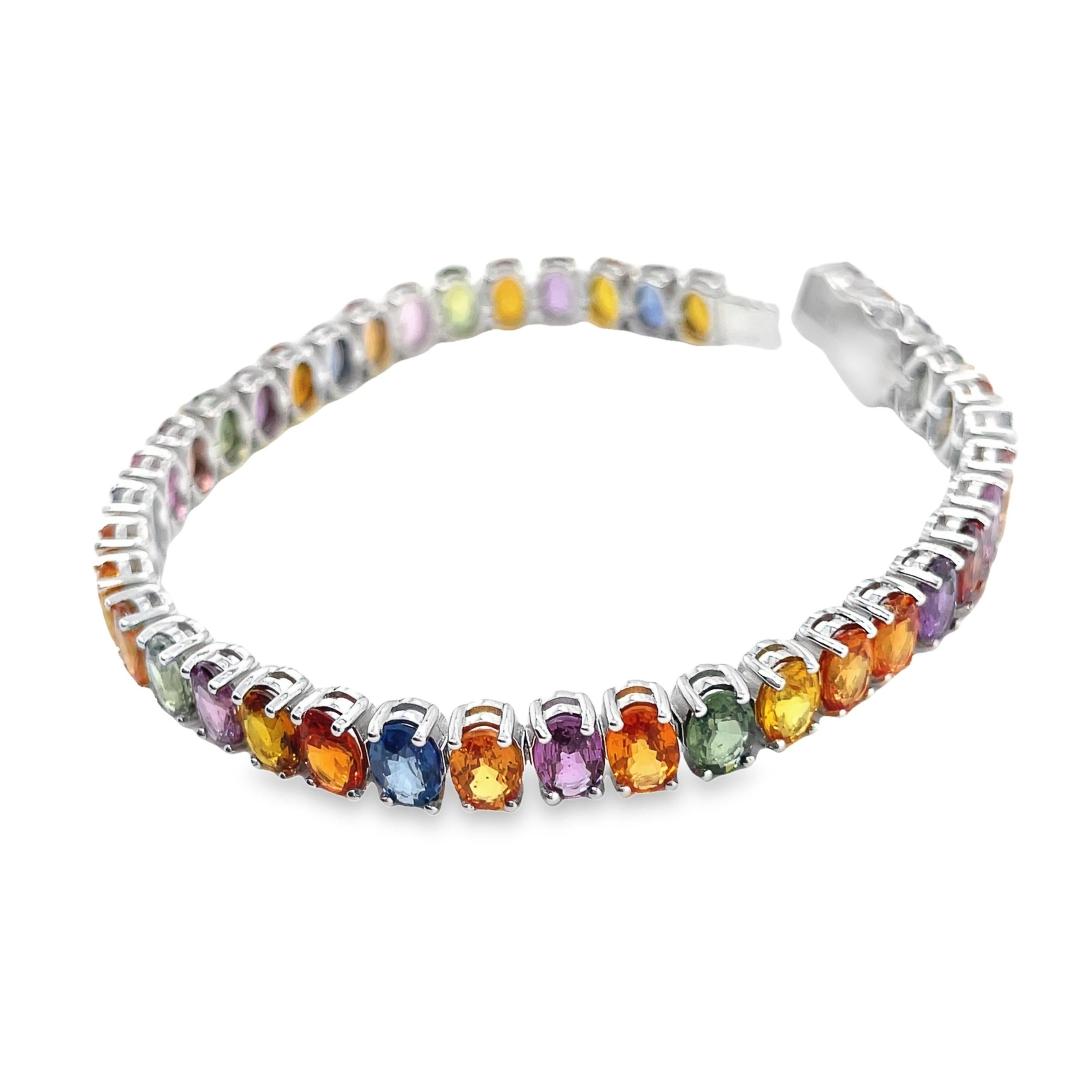 Adorn your wrist with the vibrant elegance of our IGI Certified 14K white gold bracelet, featuring 22.16 carats of natural multi-color sapphires. This exquisite piece is comprised of 40 oval mixed-cut sapphires, carefully selected for their luminous
