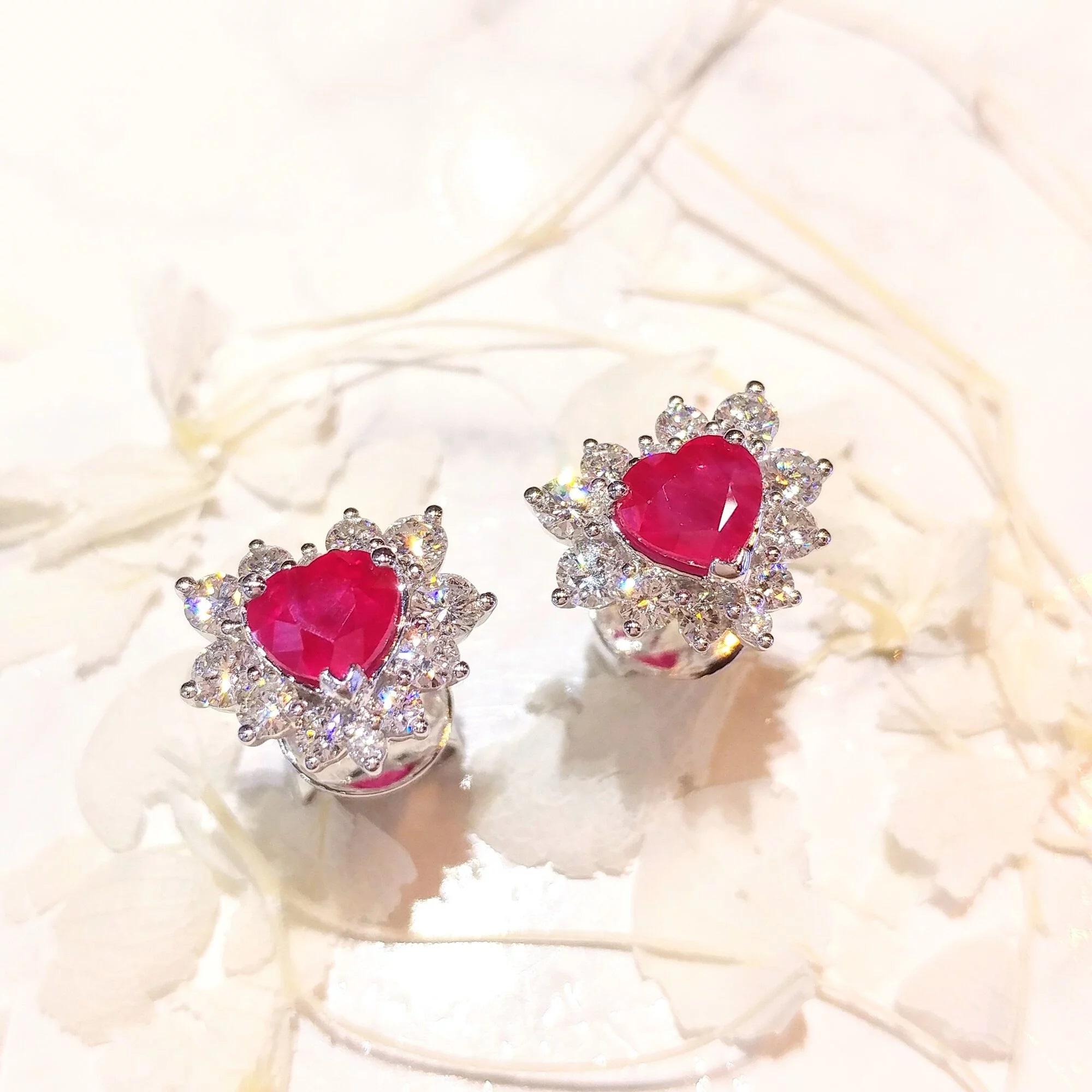 Burmese rubies are sought after for their beautiful red tones. These 18k white gold earrings featuring a 2.23 carat rare heart-shaped ruby is a great example of the Burmese allure - deep red tones with the slightest hint of purple. Halo set with