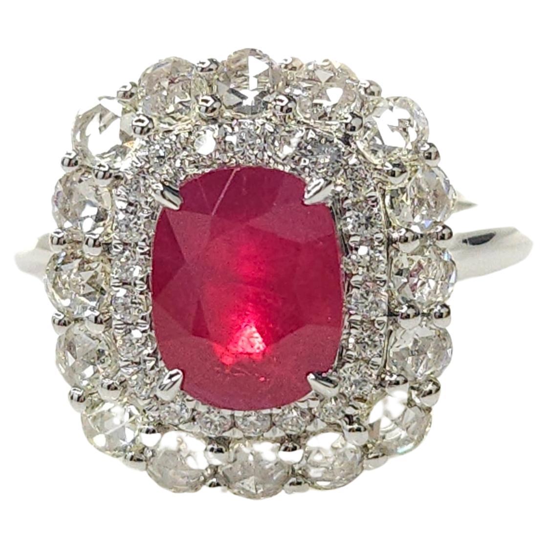 Step into the world of glamour and sophistication with this exquisite double halo ring featuring a stunning IGI Certified 2.26 Carat ruby in a deep purplish-red color, elegantly cut into a rectangular cushion shape. The intense hue of the ruby
