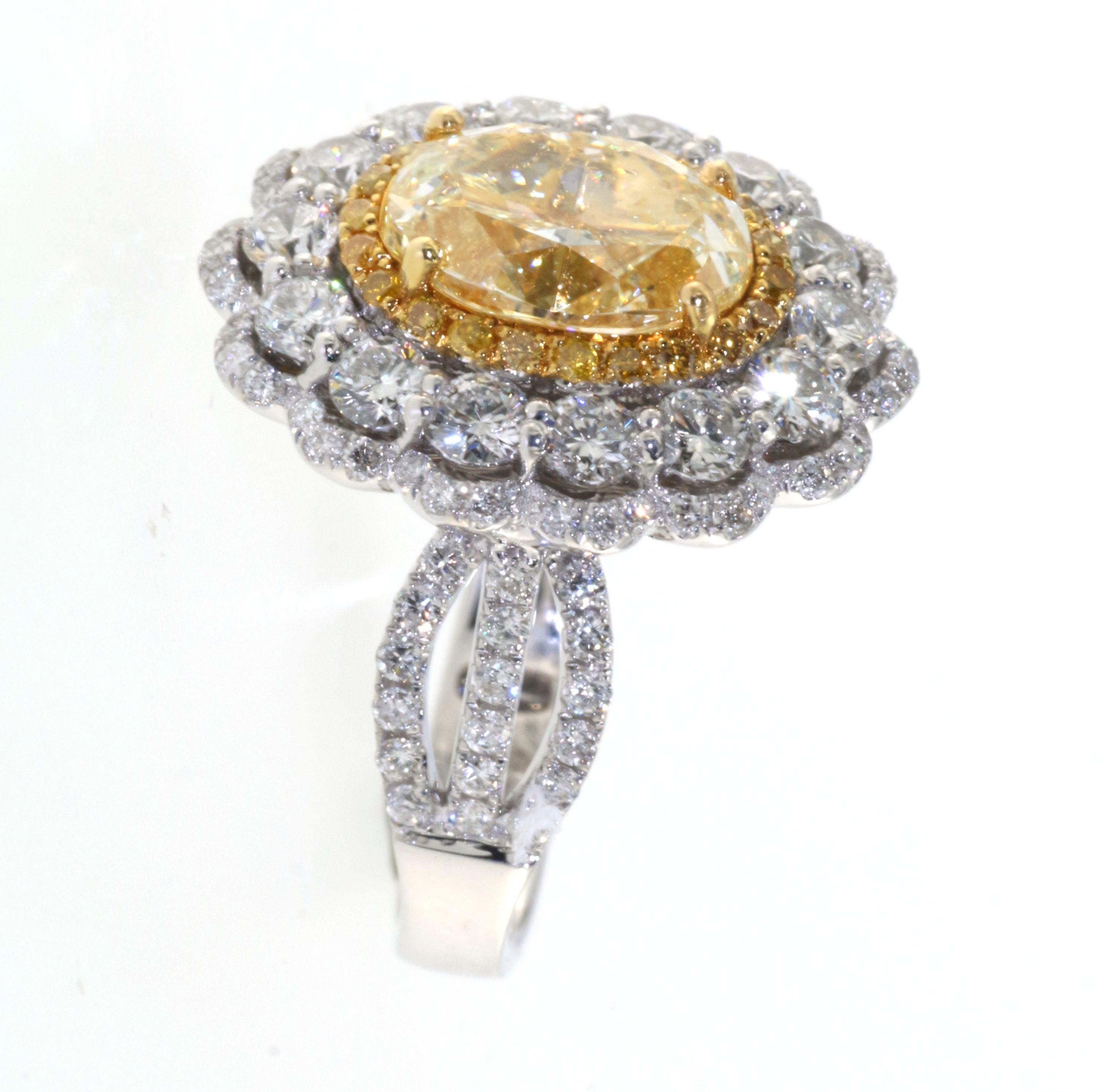 Contemporary IGI Certified 2.29 Carats N Color Yellow Diamond in 18 Karat Triple Halo Ring For Sale