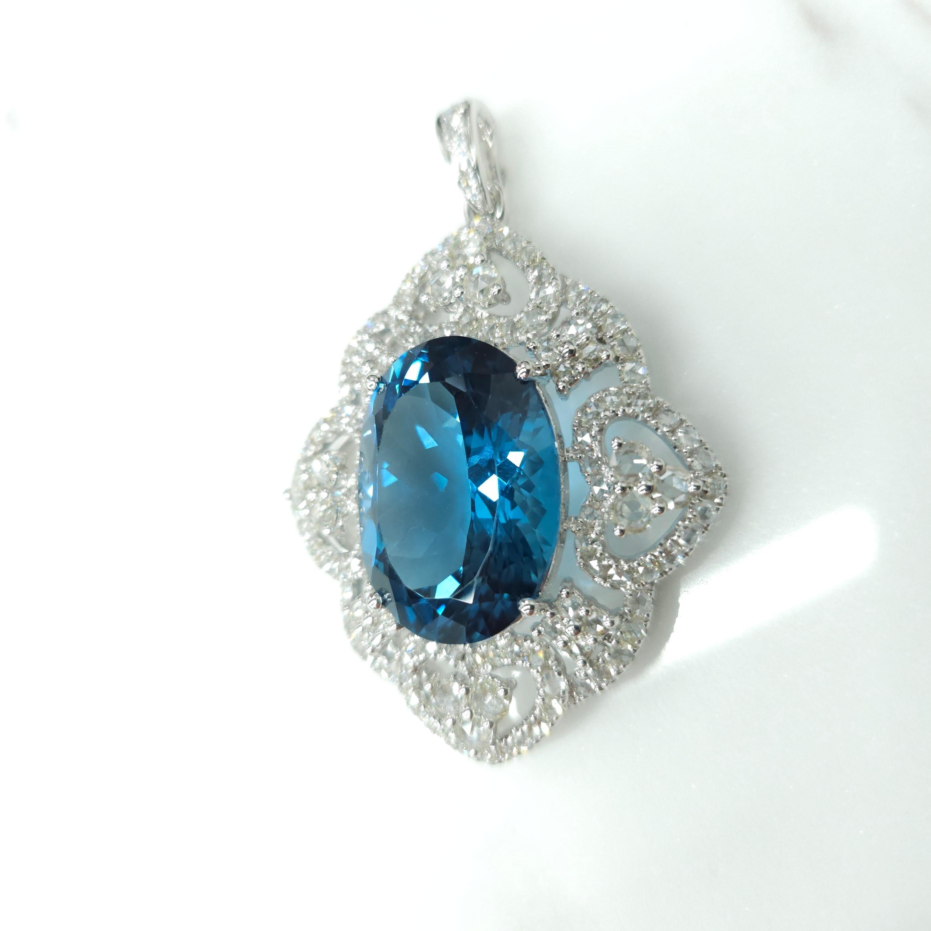 Elevate your jewelry collection with this exquisite Georgian style pendant featuring a luxurious IGI Certified 24.10 Carat natural Topaz in an intense greenish-blue hue that is truly mesmerizing. The oval shape of the topaz adds a touch of elegance