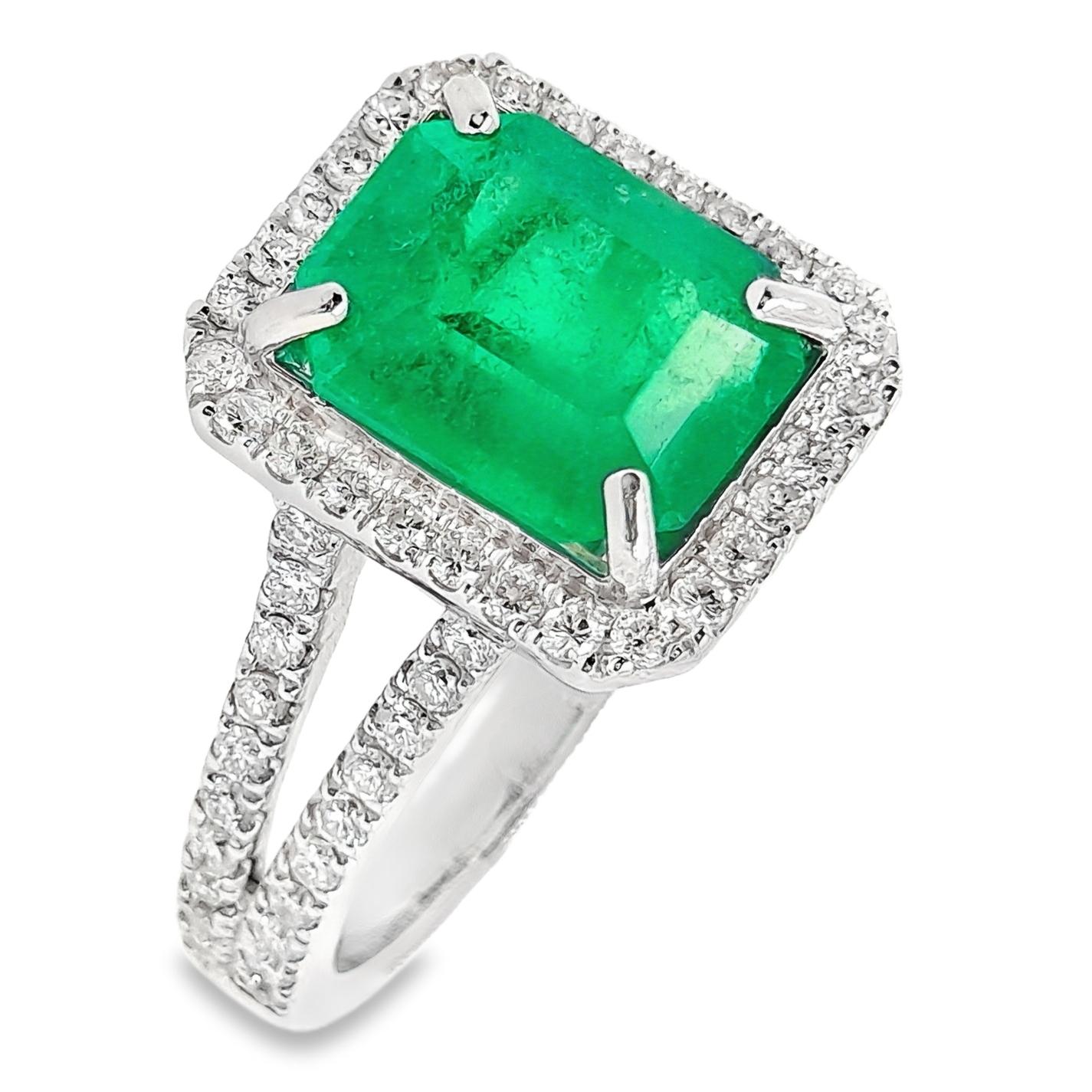 Stunning 14K white gold ring featuring a 2.44-carat natural Colombian emerald accented by 0.61 carats of natural diamonds, certified by IGI. The exquisite emerald-cut centre stone displays an intense bluish-green hue with minor clarity enhancement.