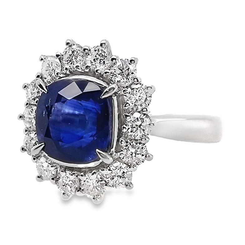 This vibrant ring from Top Crown Jewelry collection, distinctive through its display of the sapphire gem the color of the deepest oceans.
This square cushion vivid blue sapphire center stone is accented by 100% natural glistening round brilliant-cut