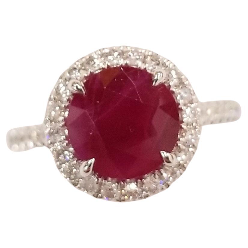 Presenting a truly remarkable piece of jewelry featuring an IGI Certified 2.48 Carat Ruby, originated from Burma/Myanmar, renowned for its deep purplish red color and rare round shape. This magnificent gemstone is showcased in a modern-style ring