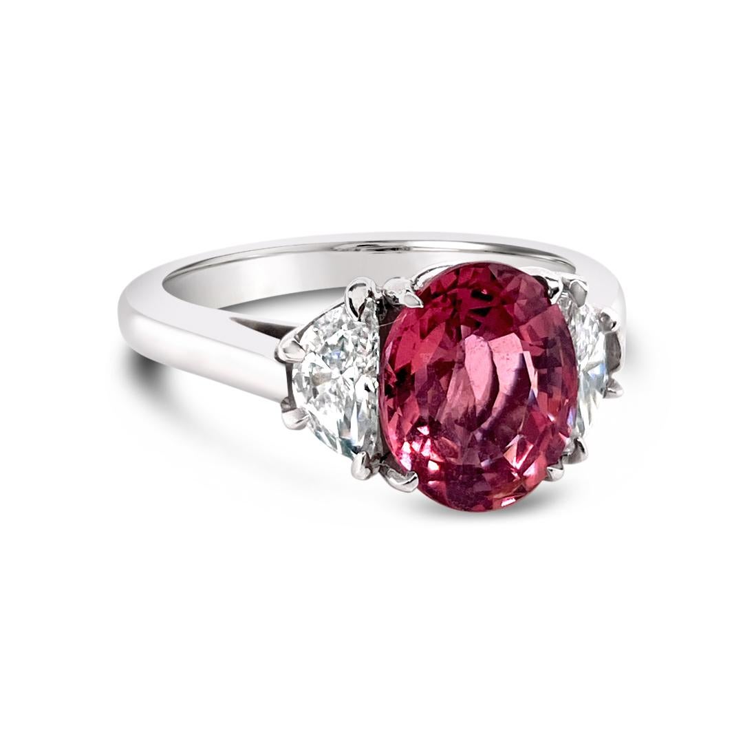 IGI certified 2.48 Carats Oval Natural/No Heat Padparadscha Sapphire ring, side set with 0.55 Carats (total weight) half moon diamonds.  Set in Platinum. 
