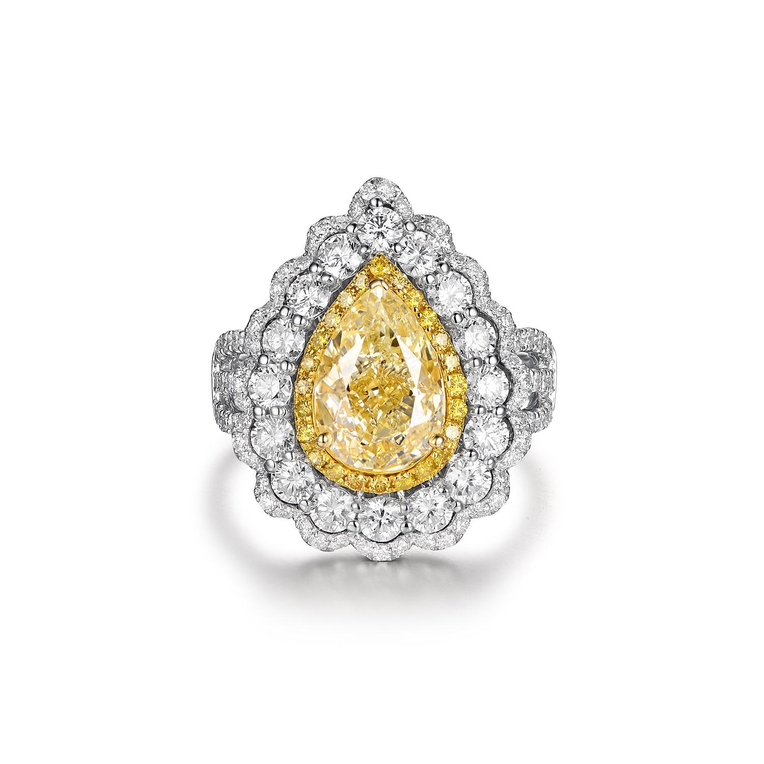 Presenting a truly exceptional piece, this Yellow Diamond Ring is an exquisite expression of luxury and beauty. The centerpiece of this ring is a remarkable IGI certified 2.51 carat VS1 N color yellow diamond, radiating a captivating hue and a