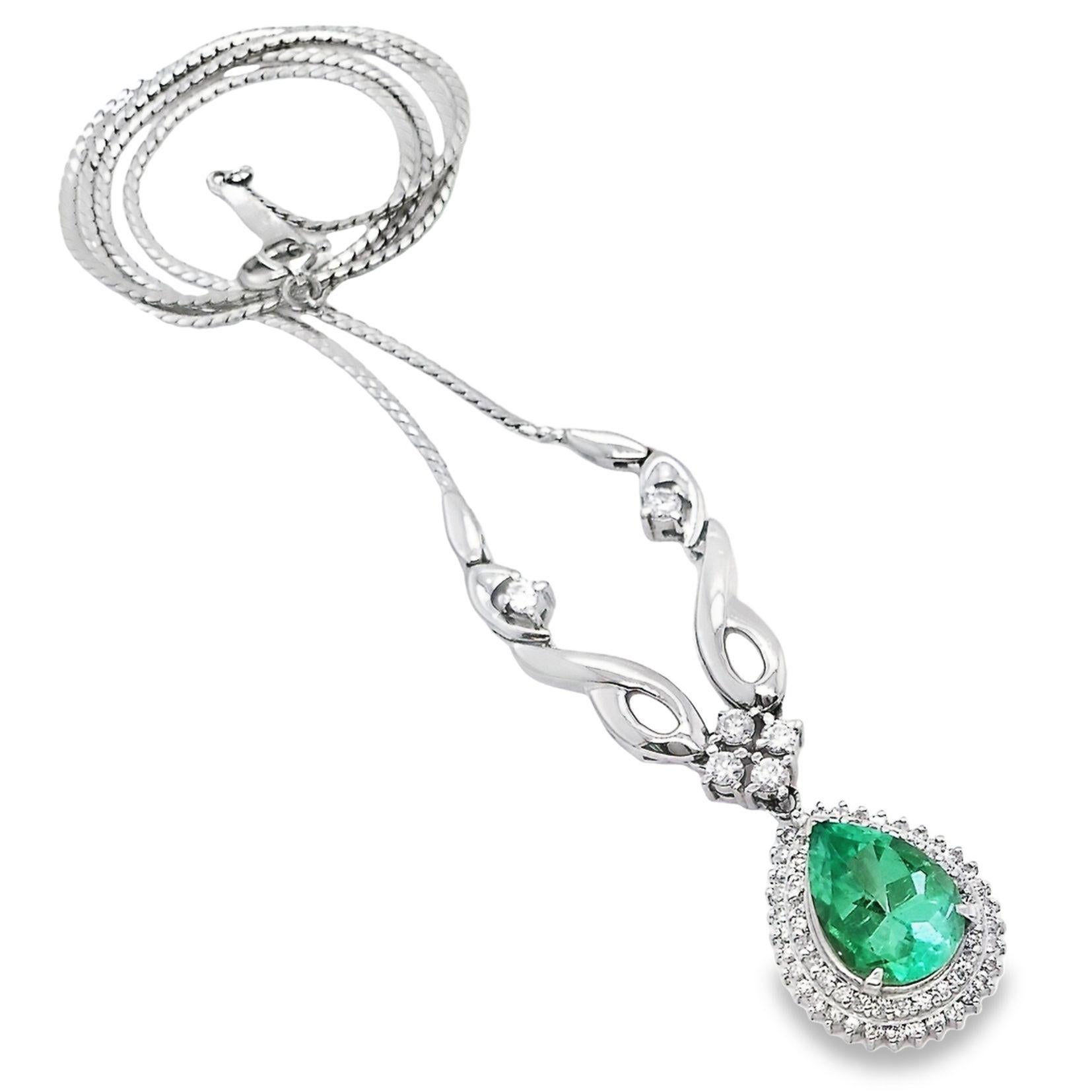 This sumptuous Colombian emerald necklace, from Top Crown Jewelry, is adorned by natural round brilliant-cut diamonds suspended on a light decorated platinum necklace. 
The necklace is 42 cm long. The pendant size is 25mm x 15mm.
This sparkling pear