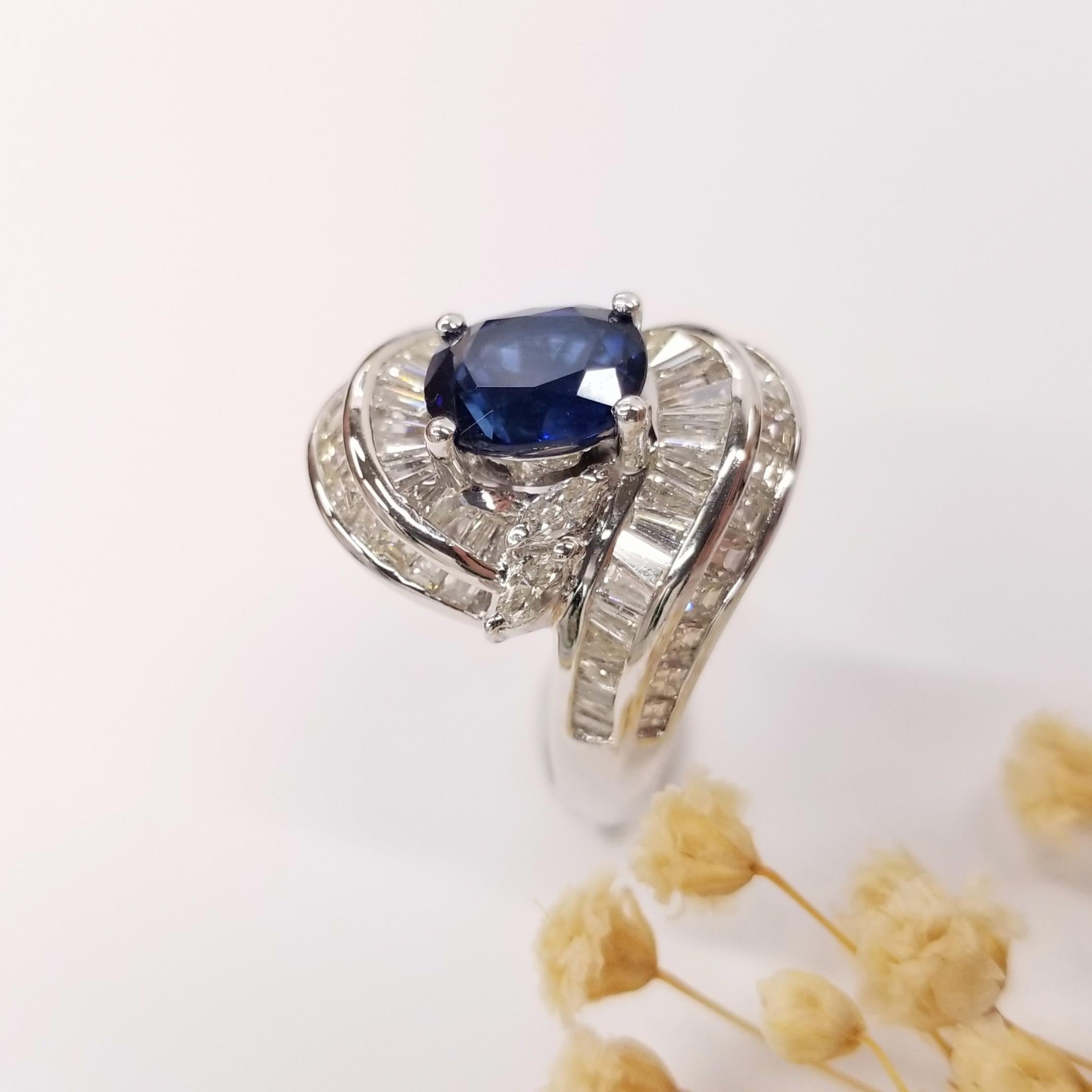 Indulge in the nostalgia and elegance of the 1990s with this exceptional vintage design swirl ring. Expertly crafted in 18K white gold, this ring showcases a stunning 2.78 carat vivid violetish blue sapphire in a captivating oval shape. The